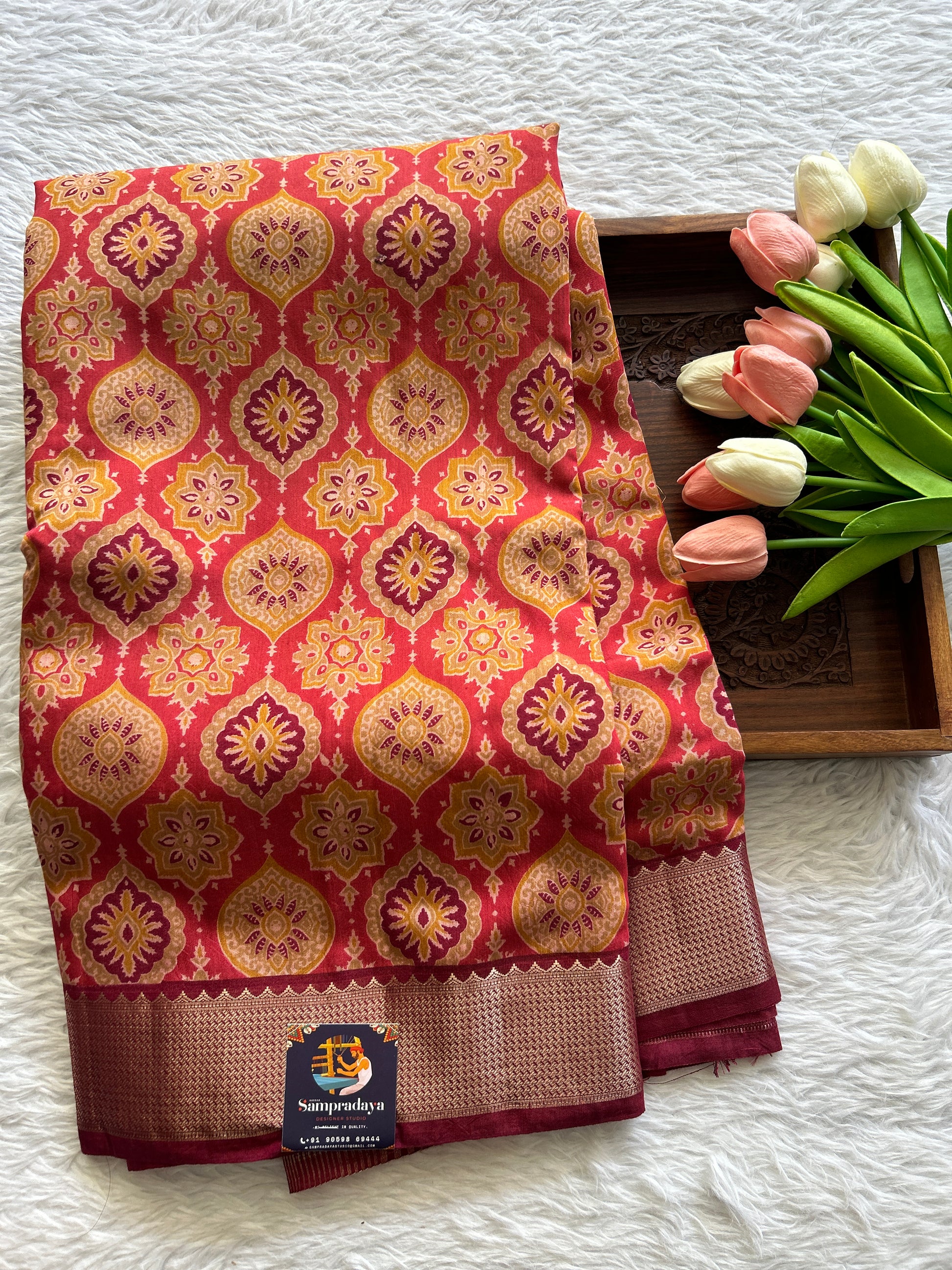 Dola Crepe Saree Dark Peach Colored Complemented with a Maroon Color Zari Border. - Sampradaya Designer Studio