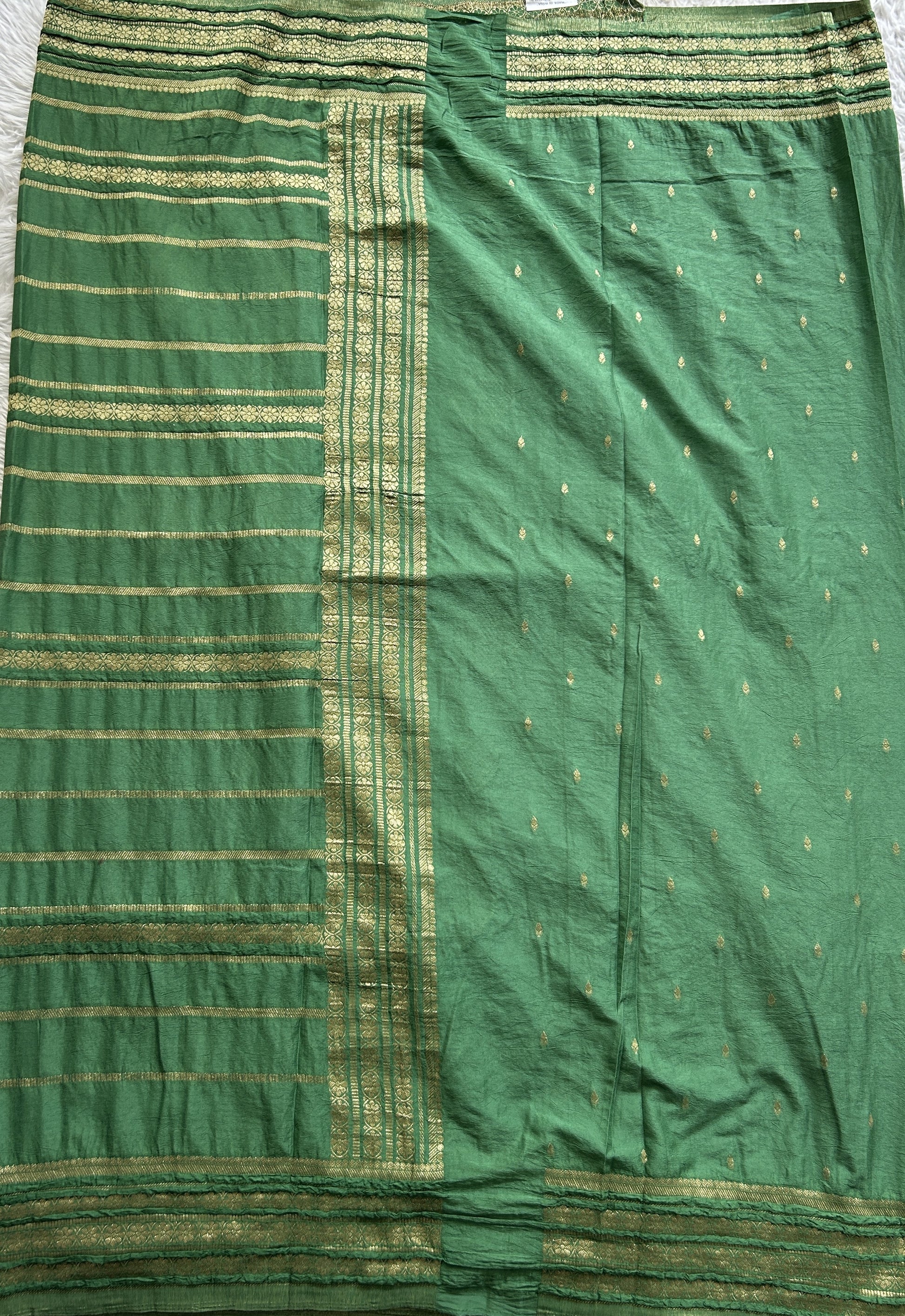 Semi Georgette Saree Green Colored Complemented with a Zari Border. - Sampradaya Designer Studio