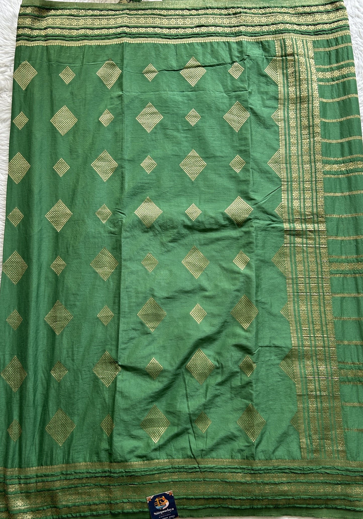 Semi Georgette Saree Green Colored Complemented with a Zari Border. - Sampradaya Designer Studio