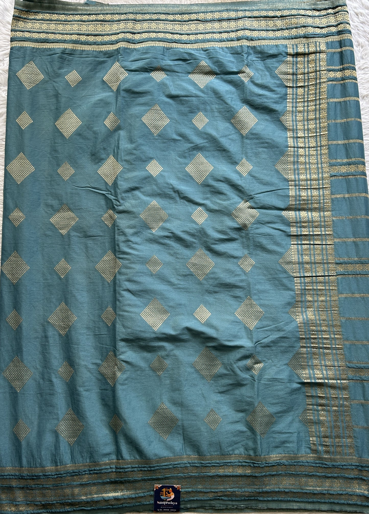 Semi Georgette Saree Teal Blue Colored Complemented with a Zari Border. - Sampradaya Designer Studio