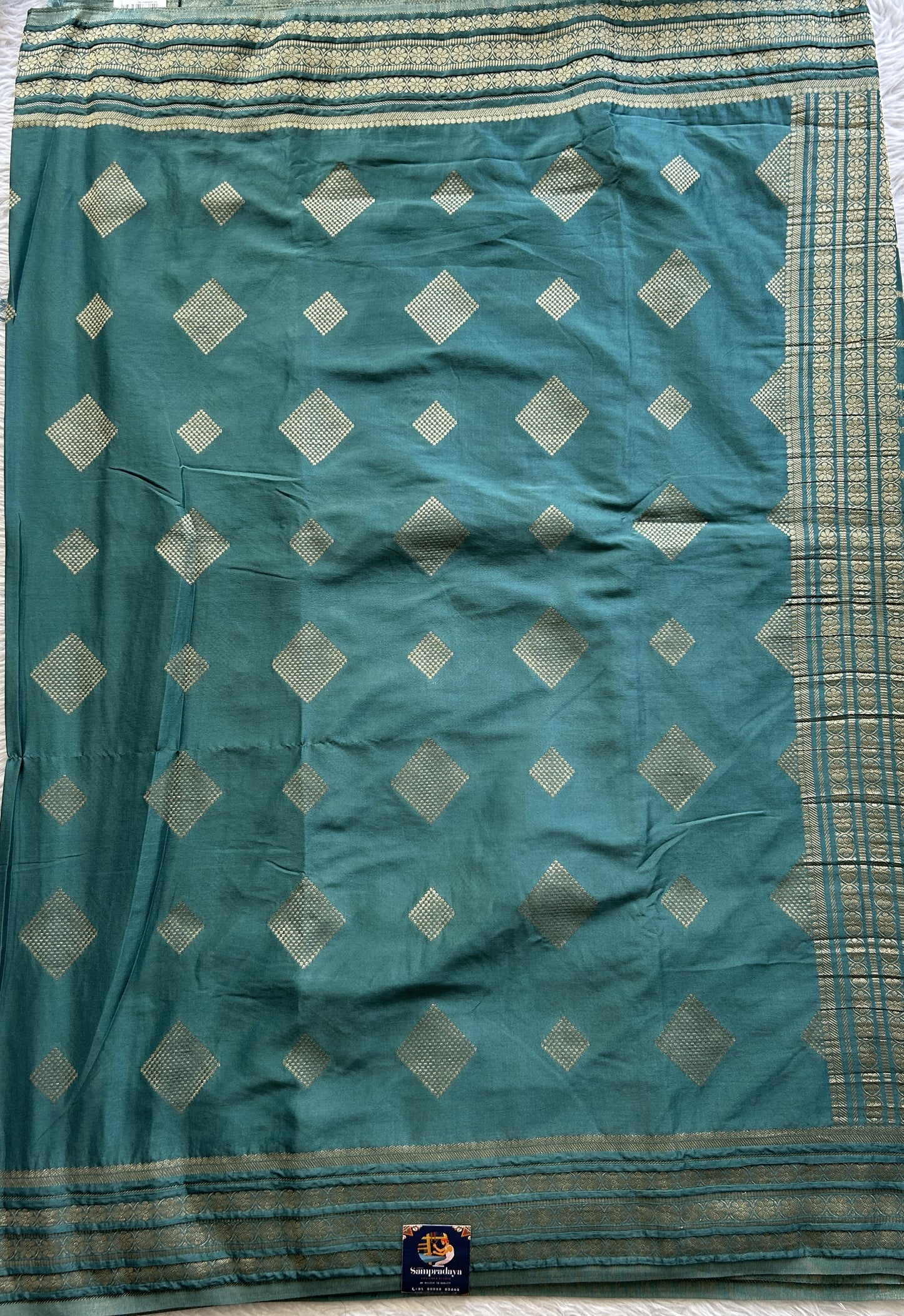 Semi Georgette Saree Pine Green Colored Complemented with a Zari Border. - Sampradaya Designer Studio