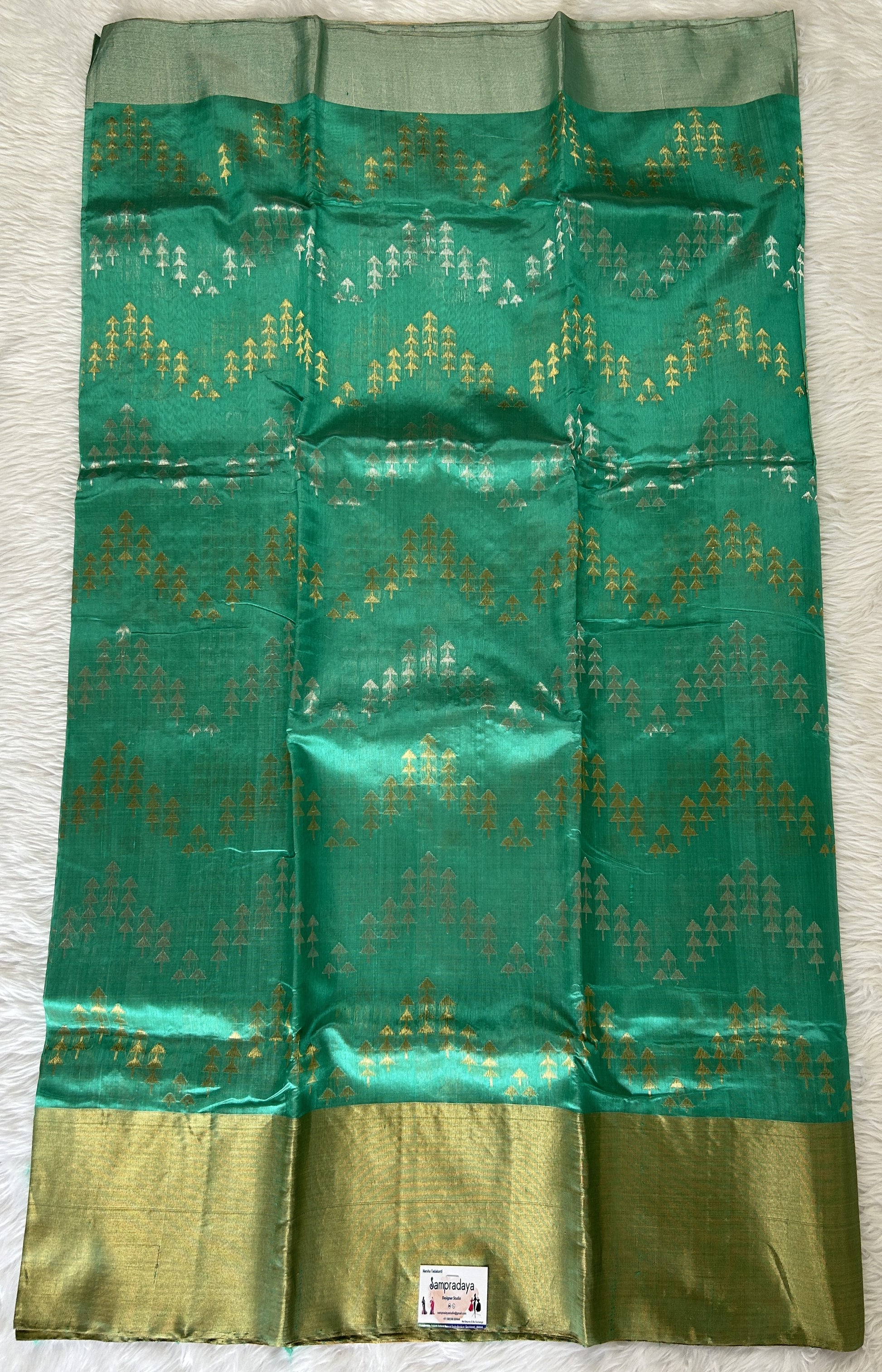 Chanderi Pattu Saree Rama Green colored saree complemented with a Gold & Silver Zari border - Sampradaya Designer Studio