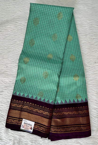 Gadwal Pattu Saree Emerald Green colored saree complemented with a Violet Color Kanchi Border - Sampradaya Designer Studio