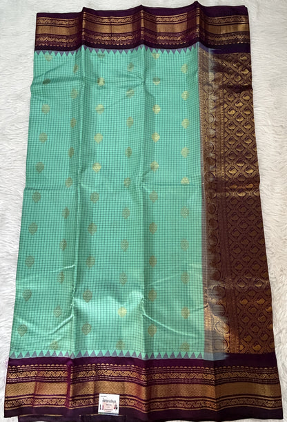 Gadwal Pattu Saree Emerald Green colored saree complemented with a Violet Color Kanchi Border - Sampradaya Designer Studio