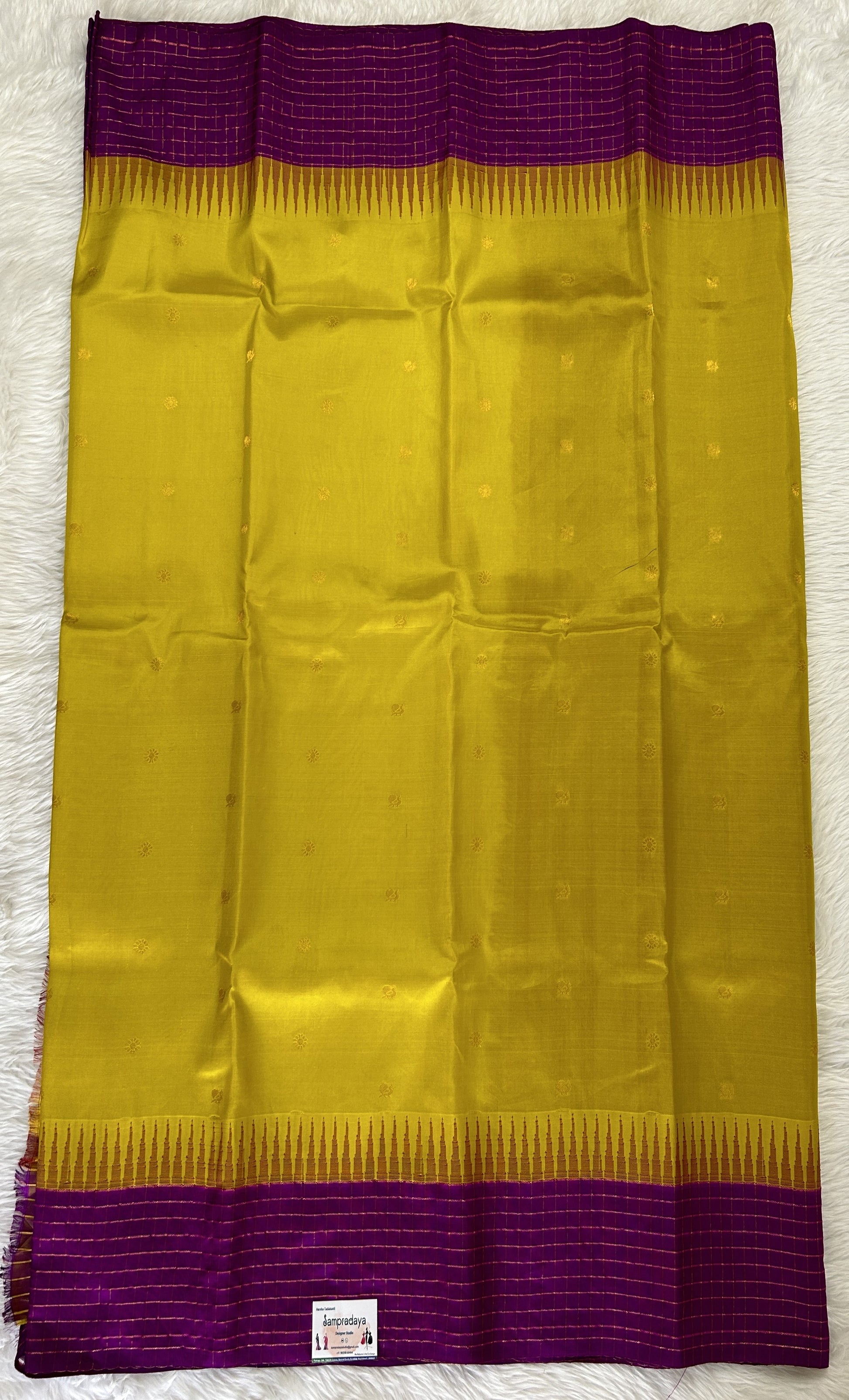 Gadwal Pattu Saree Yellow colored saree complemented with a Purple Checks Border - Sampradaya Designer Studio