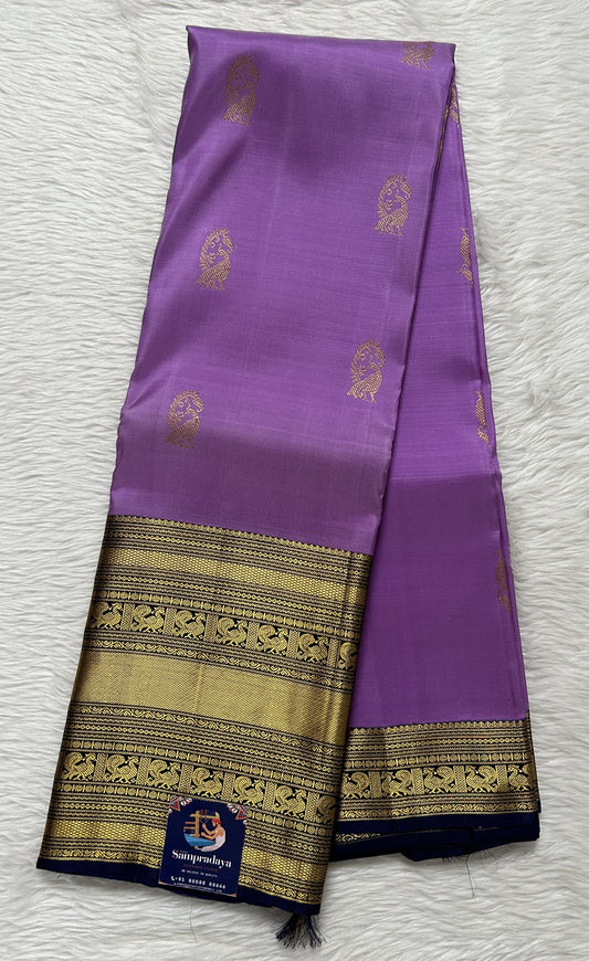 Kanjivaram Festive Silk Saree Lavender colored Saree complemented with a Navy Blue Colored Gold Kanchi border. - Sampradaya Designer Studio