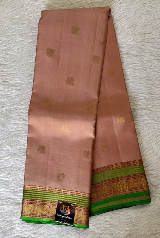 Kanjivaram Festive Silk Saree Light Peach colored Saree complemented with a Green Colored Kanchi border. - Sampradaya Designer Studio