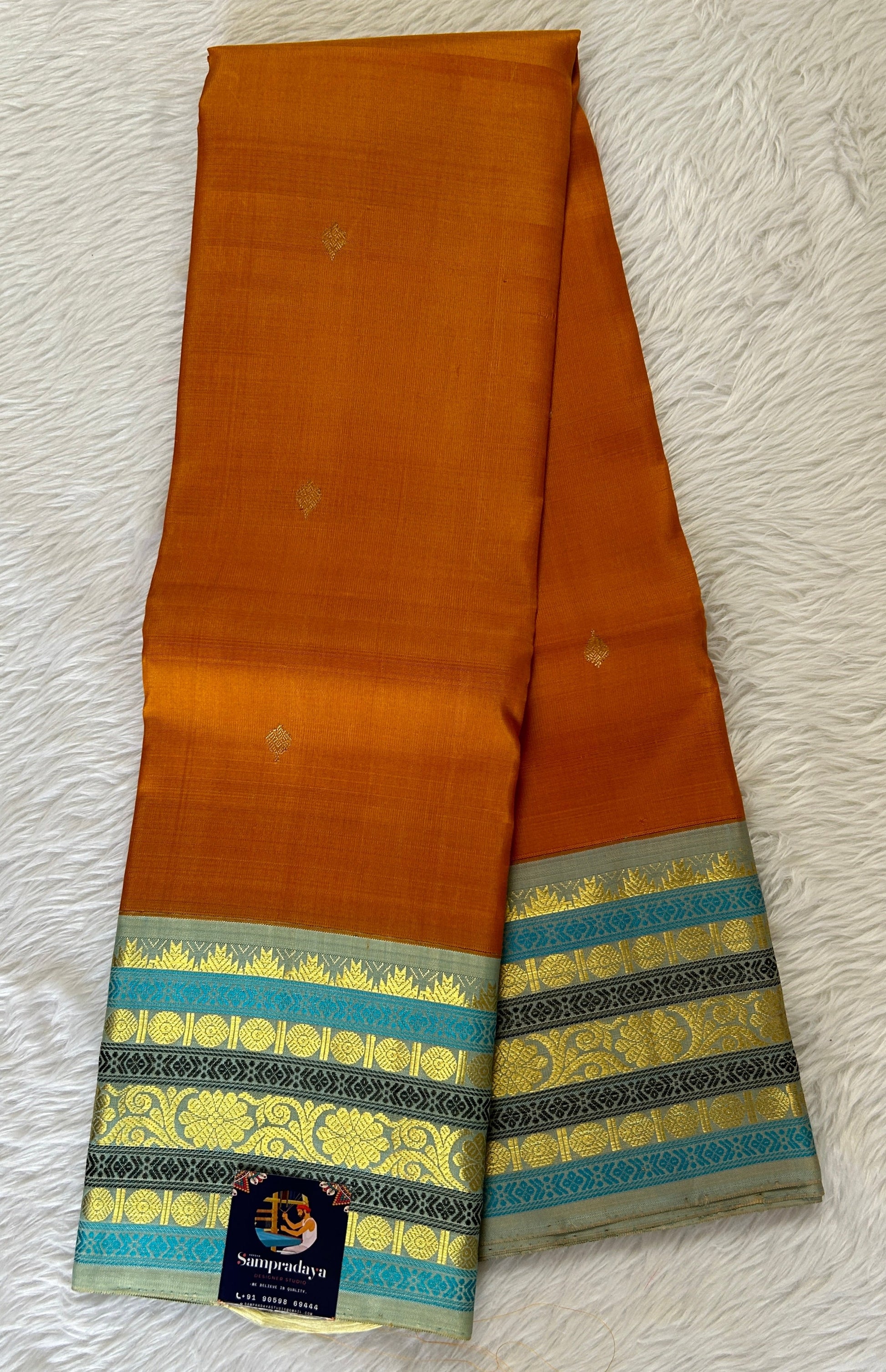 Kanjivaram Festive Silk Saree Orange colored Saree complemented with a Pastel Blue Colored Kanchi border. - Sampradaya Designer Studio