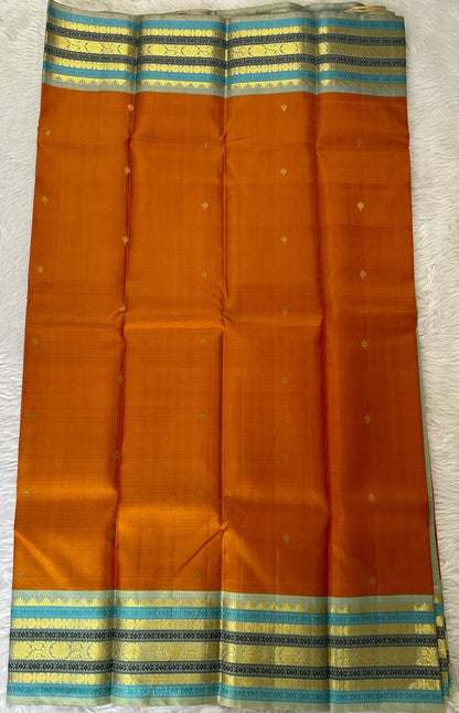 Kanjivaram Festive Silk Saree Orange colored Saree complemented with a Pastel Blue Colored Kanchi border. - Sampradaya Designer Studio