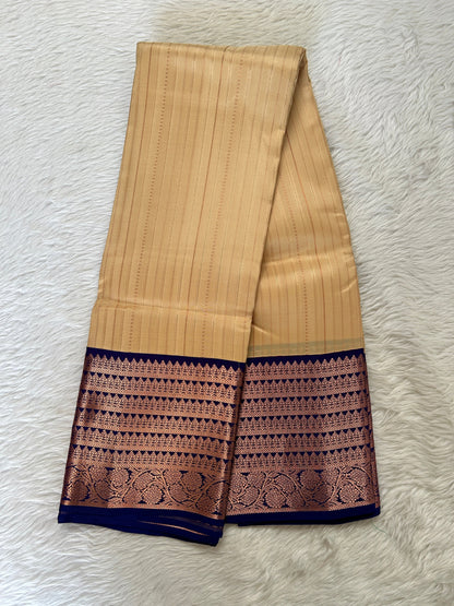 Kanjivaram Festive Silk Saree Cream colored Saree complemented with a Blue Colored Kanchi border. - Sampradaya Designer Studio