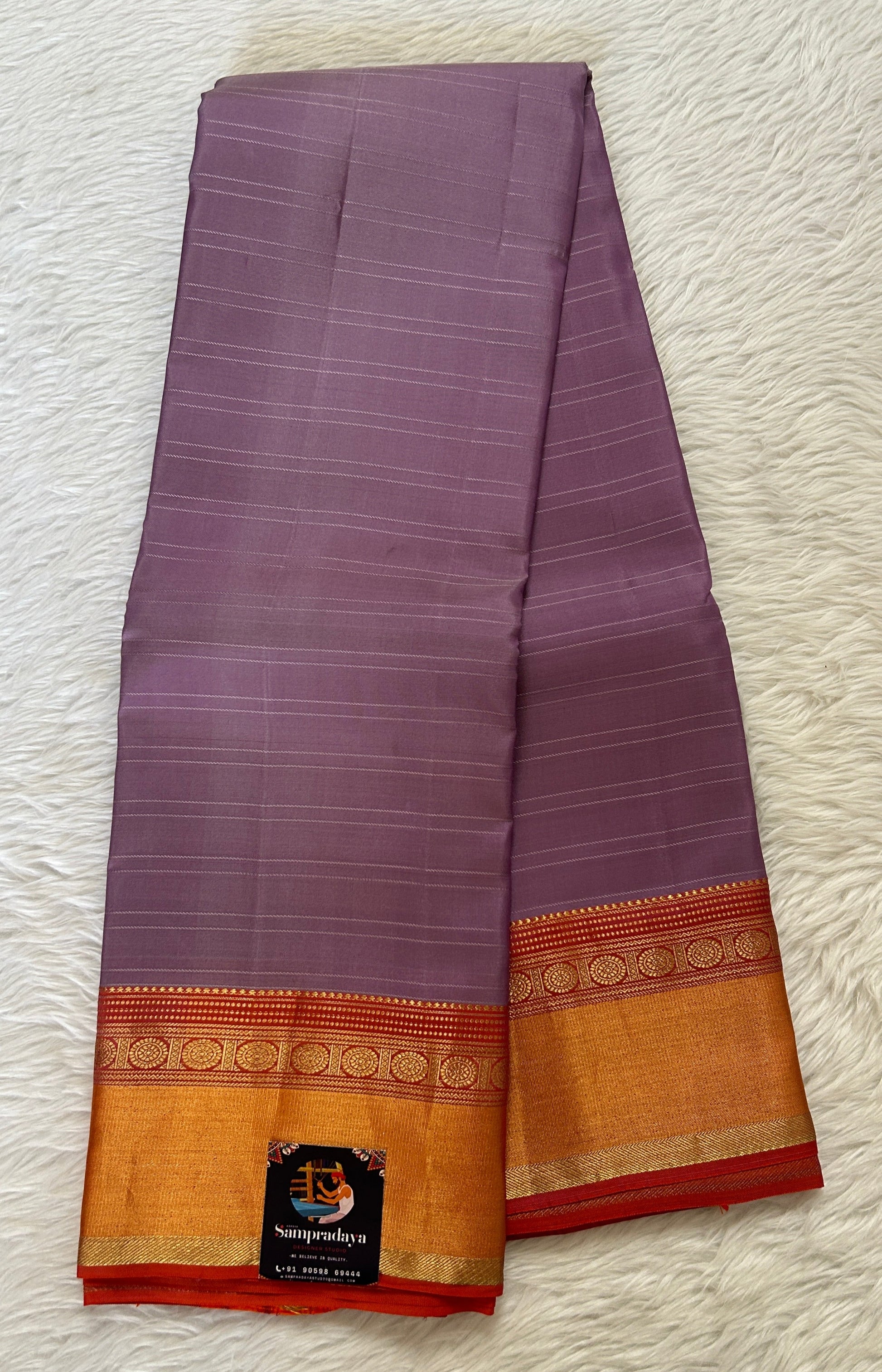 Kanjivaram Festive Silk Saree Lavender colored Saree complemented with a Orange Colored Kanchi border. - Sampradaya Designer Studio