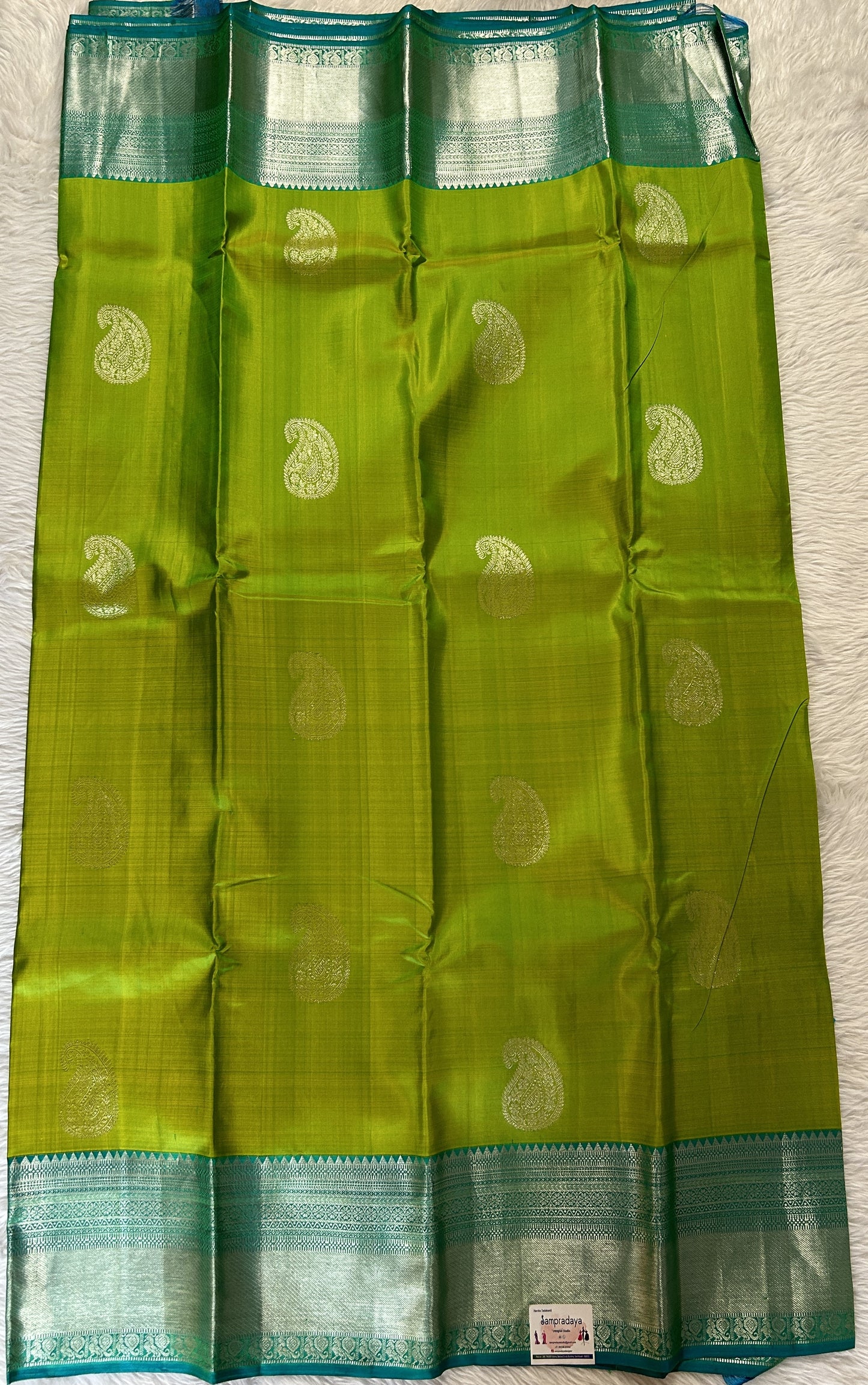 Kanjivaram Festive Silk Saree Green colored Saree complemented with a Blue Kanchi border. - Sampradaya Designer Studio