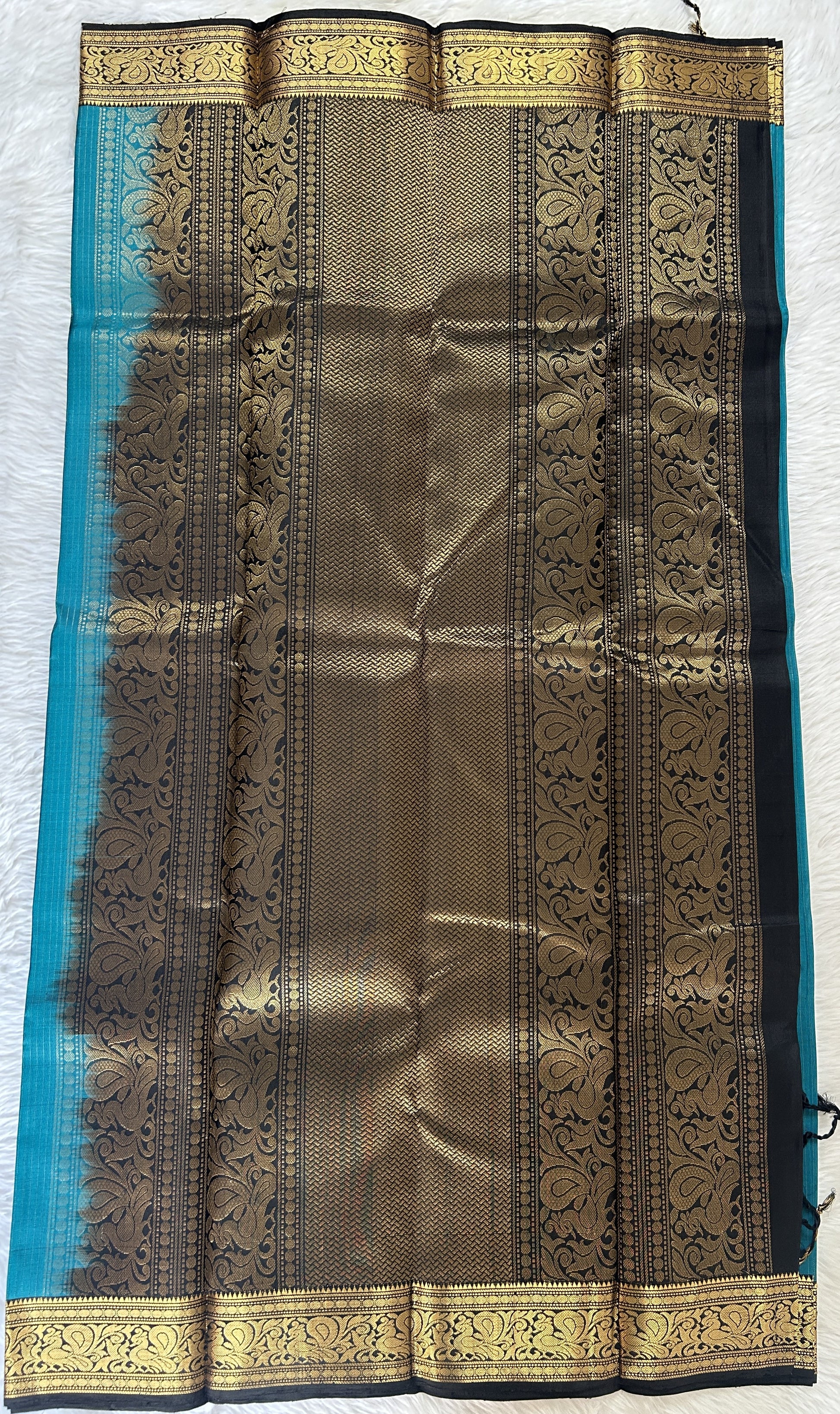 Kanjivaram Festive Silk Saree Peacock Green colored Saree complemented with a Black Colored Gold Kanchi border. - Sampradaya Designer Studio