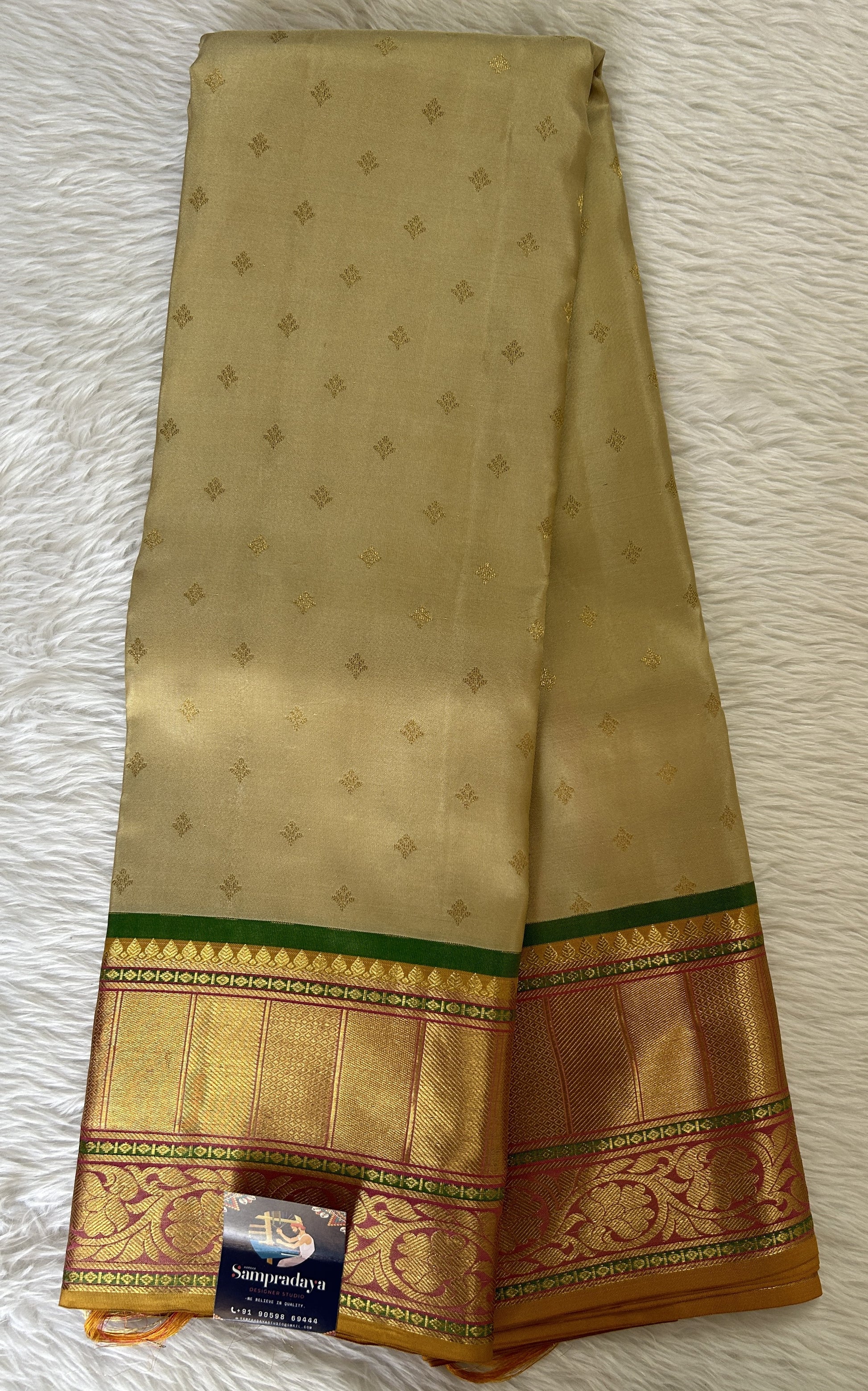 Kanjivaram Festive Silk Saree Biscuit colored Saree complemented with a Pink Colored Gold Kanchi border. - Sampradaya Designer Studio