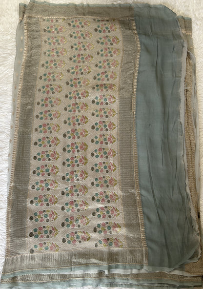 Banarasi Georgette Silk Saree Ash Green colored Saree complemented with a Silver Zari border. - Sampradaya Designer Studio