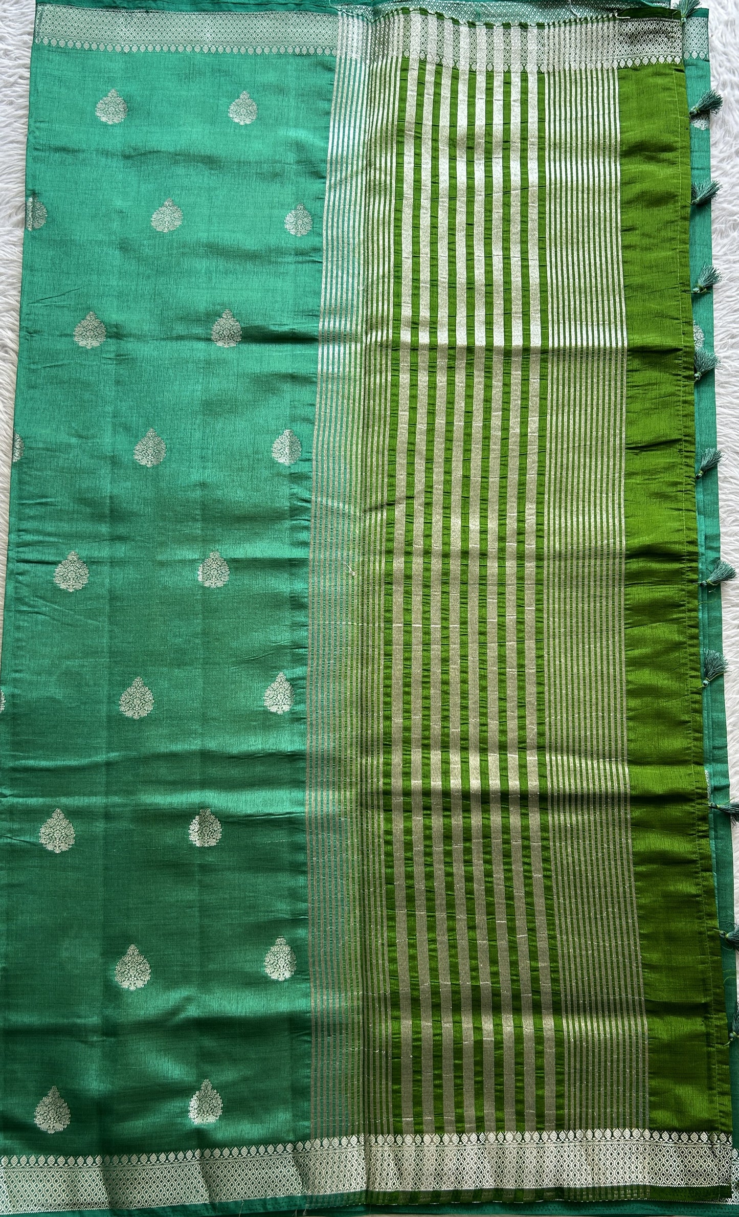 Semi Tussar Saree Bottle Green Colored complemented with a Zari Border. - Sampradaya Designer Studio