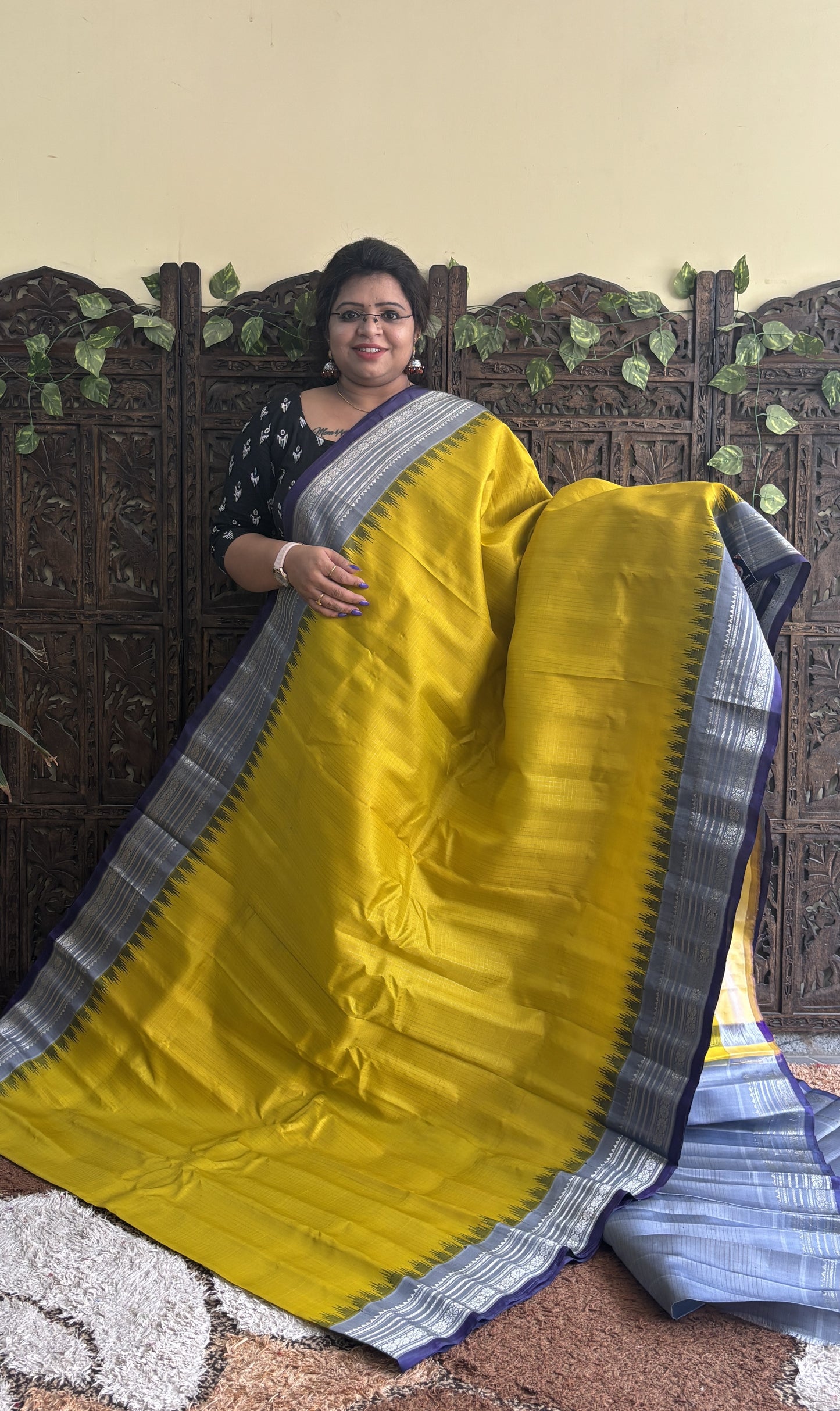 Gadwal Silk Saree Yellow Colored Complemented With a Gray Zari Border