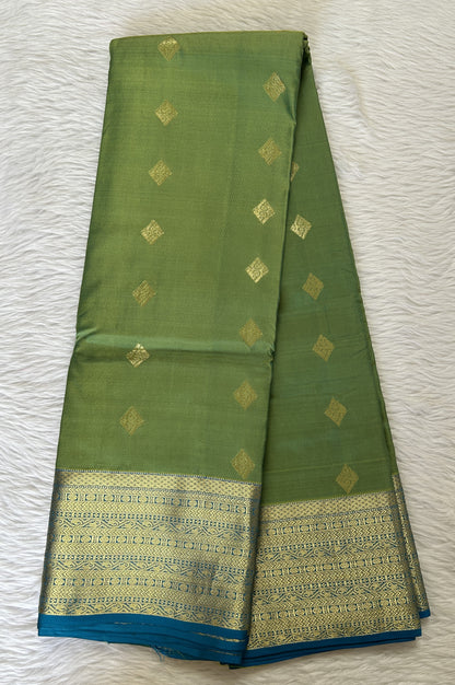 Kanjivaram Powerloom Silk Saree Green colored Saree complemented with a Blue Colored Gold Kanchi border. - Sampradaya Designer Studio