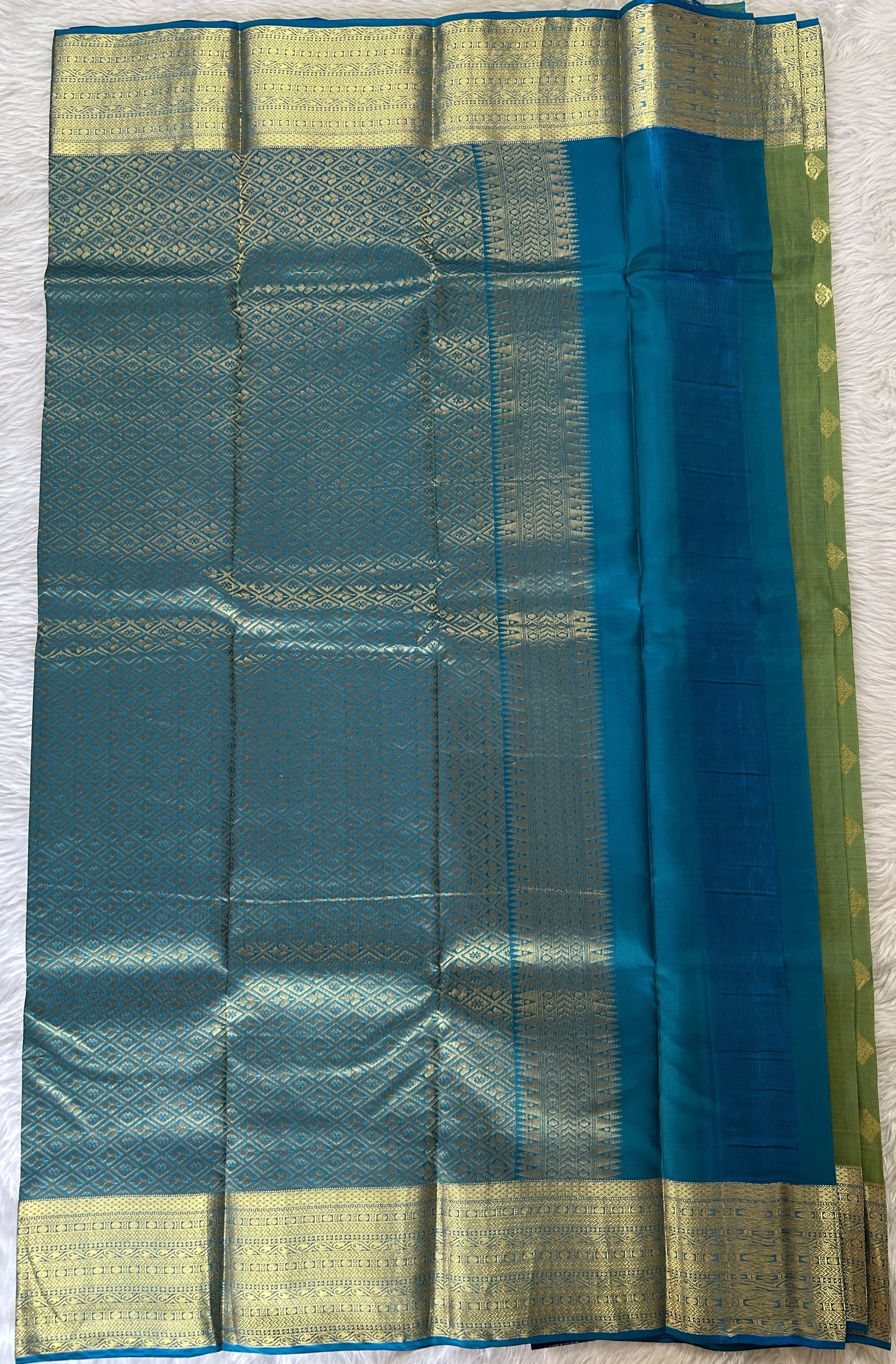 Kanjivaram Powerloom Silk Saree Green colored Saree complemented with a Blue Colored Gold Kanchi border. - Sampradaya Designer Studio