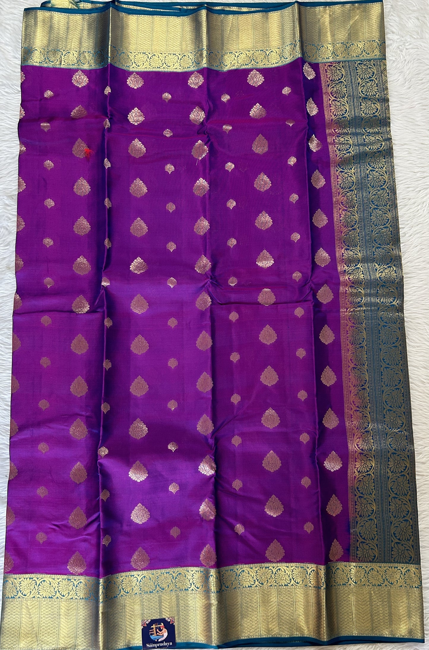 Kanjivaram Powerloom Silk Saree Magenta colored Saree complemented with a Dark Blue Colored Gold Kanchi border. - Sampradaya Designer Studio