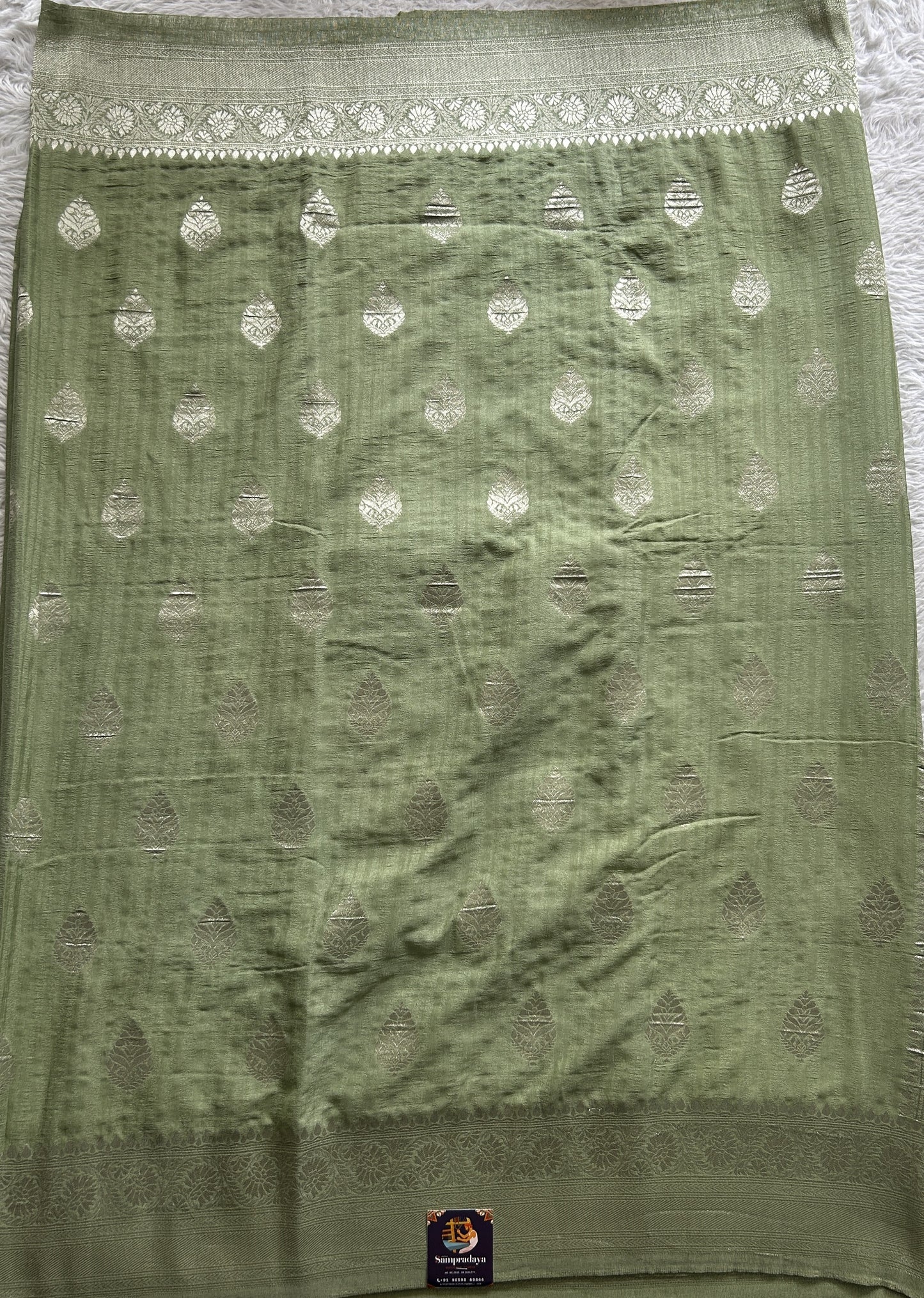 Semi Georgette Saree Pista Green Colored Complemented with a Zari Border. - Sampradaya Designer Studio