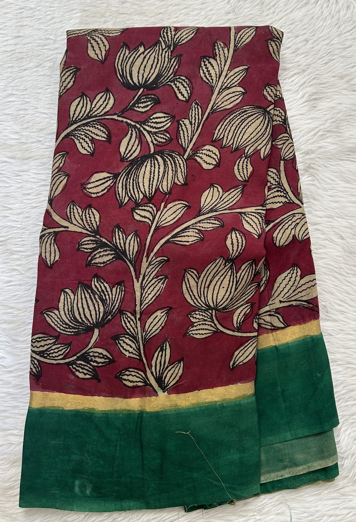 Pen Kalamkari Saree Maroon colored allover saree complemented with a Dark Green Colored Plain border - Sampradaya Designer Studio