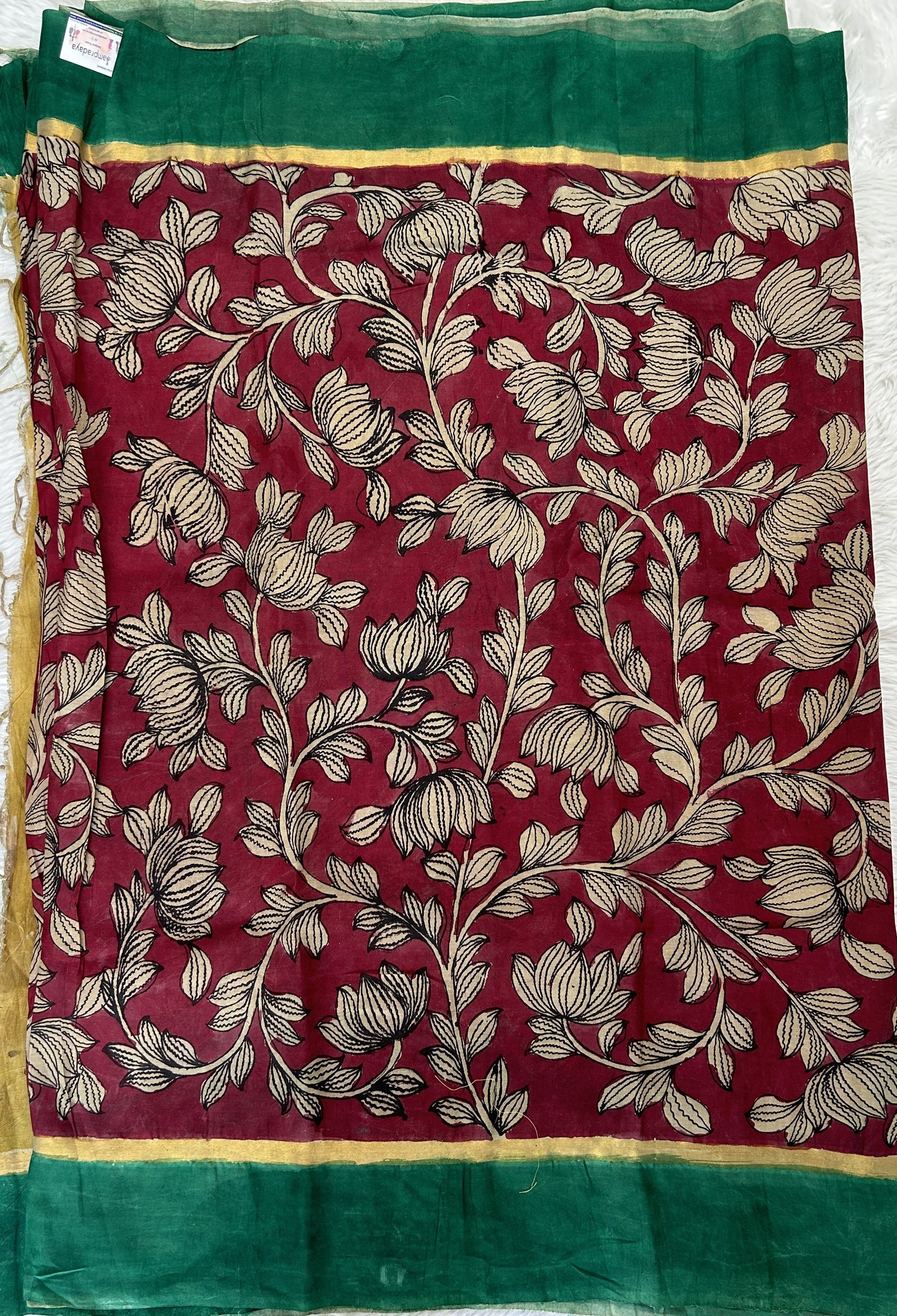 Pen Kalamkari Saree Maroon colored allover saree complemented with a Dark Green Colored Plain border - Sampradaya Designer Studio