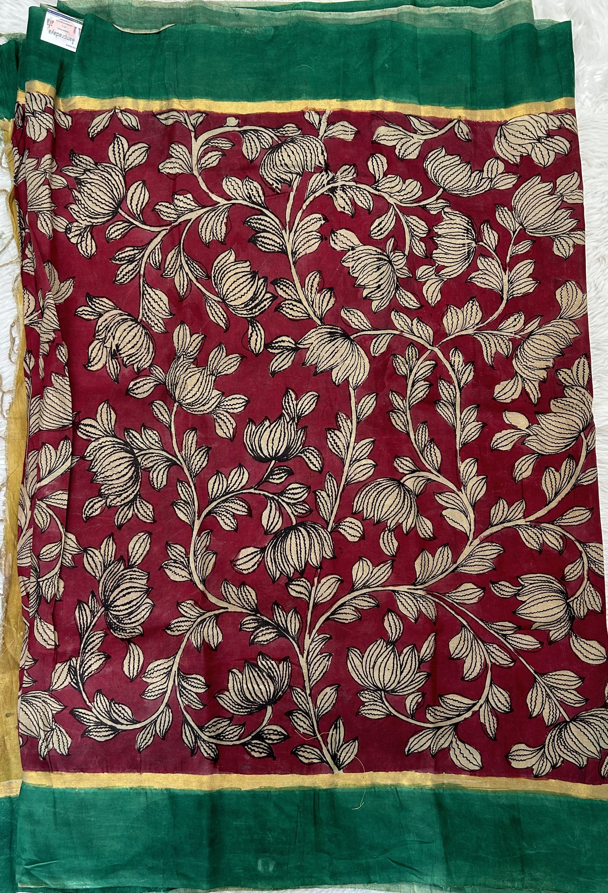 Pen Kalamkari Saree Maroon colored allover saree complemented with a Dark Green Colored Plain border - Sampradaya Designer Studio