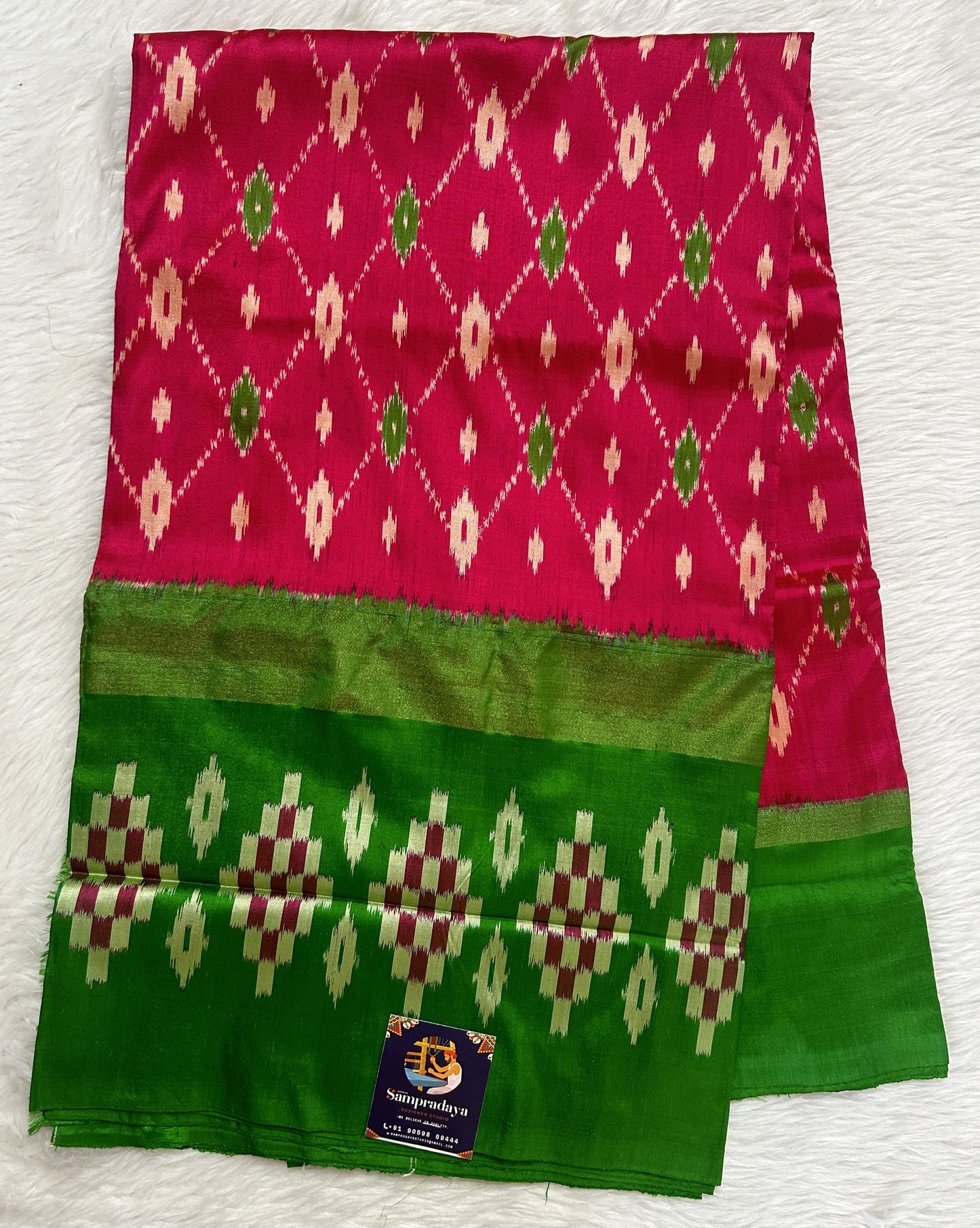 Ikkat Pattu Saree Pink colored Saree complemented with a Green Colored Ikkat border. - Sampradaya Designer Studio