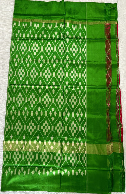 Ikkat Pattu Saree Pink colored Saree complemented with a Green Colored Ikkat border. - Sampradaya Designer Studio