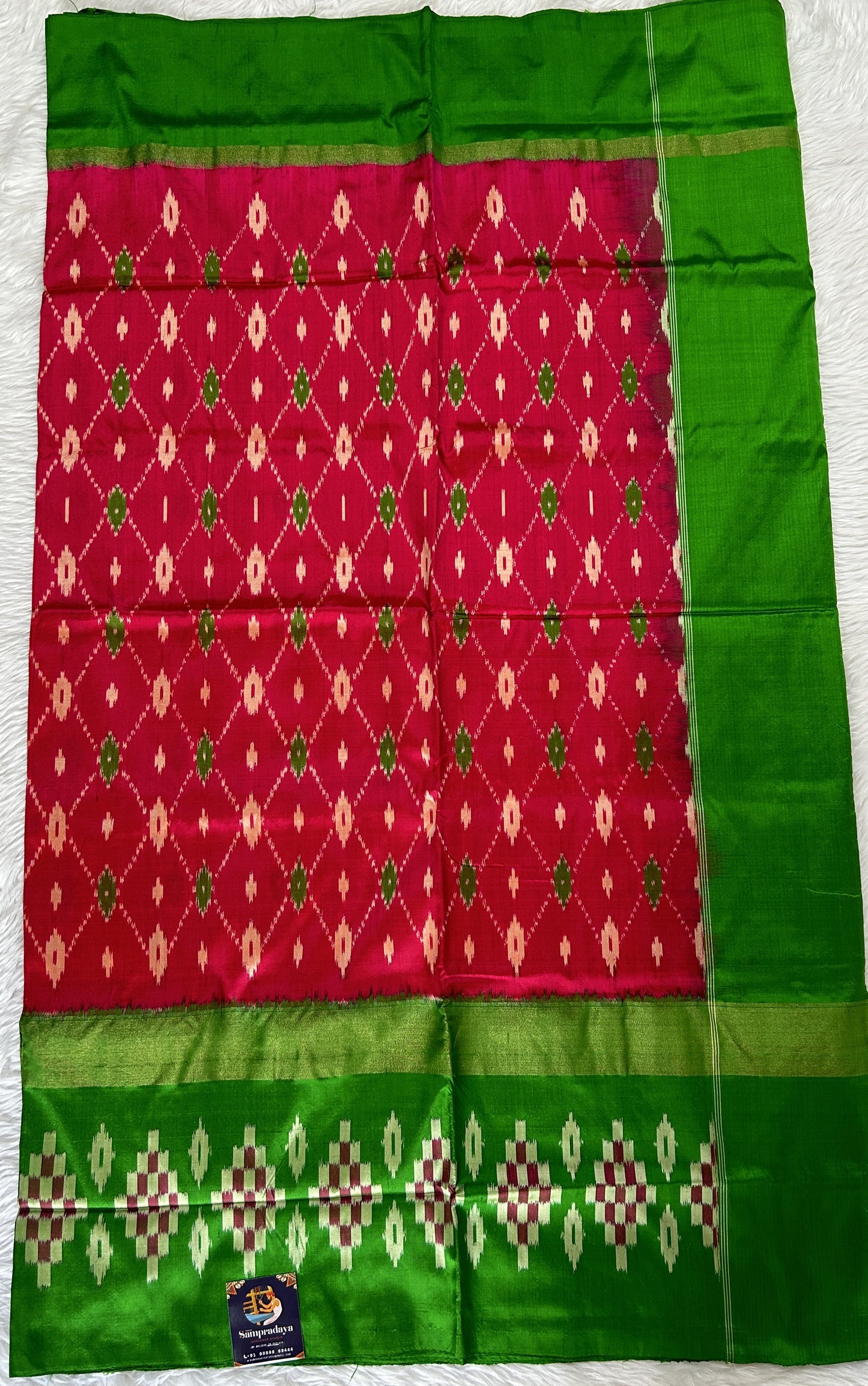 Ikkat Pattu Saree Pink colored Saree complemented with a Green Colored Ikkat border. - Sampradaya Designer Studio