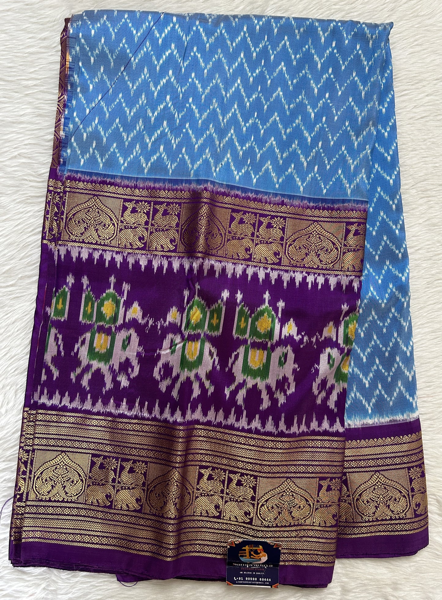 Ikkat Pattu Saree Blue colored Saree complemented with a Purple Colored Kanchi border. - Sampradaya Designer Studio