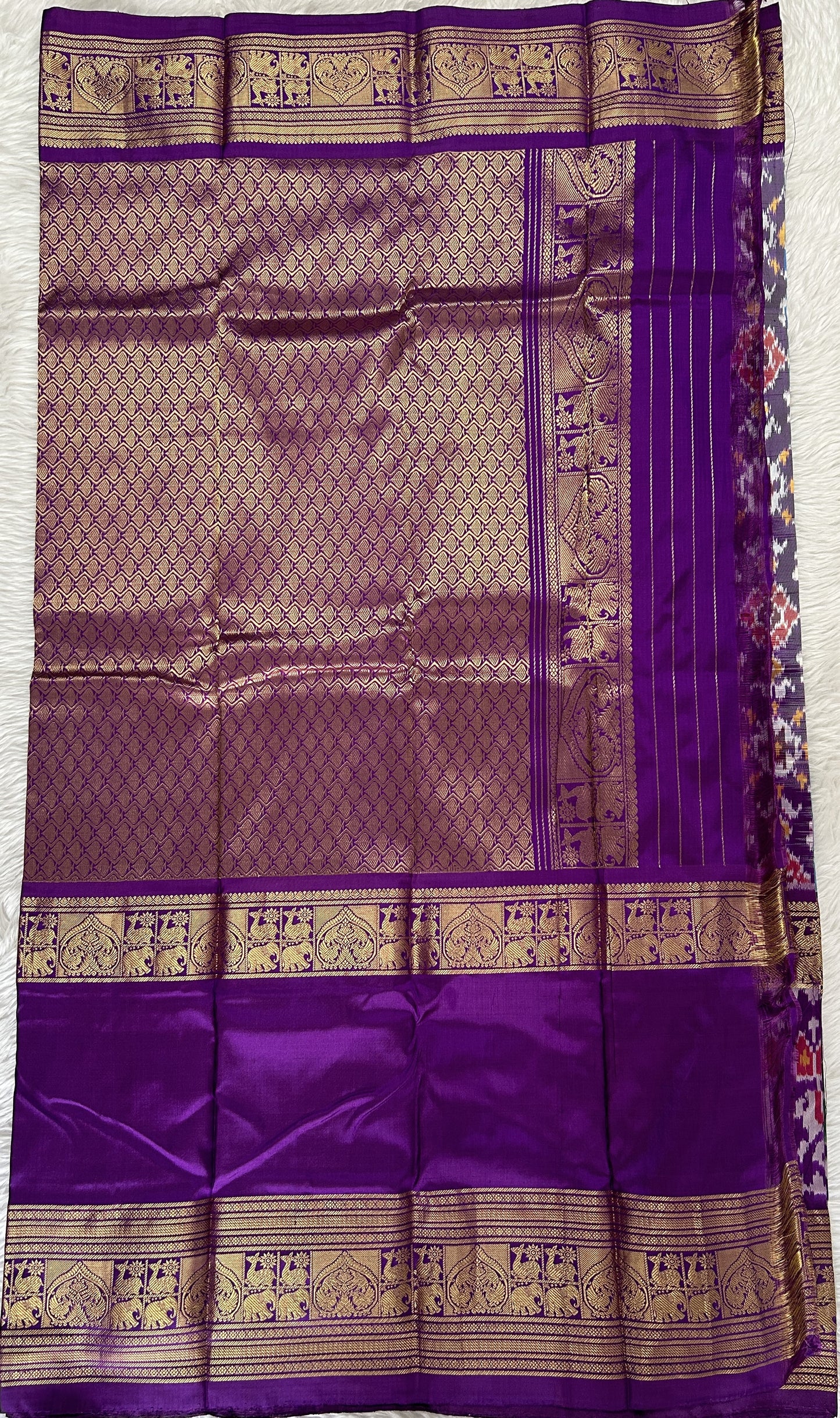 Ikkat Pattu Saree Blue colored Saree complemented with a Purple Colored Kanchi border. - Sampradaya Designer Studio