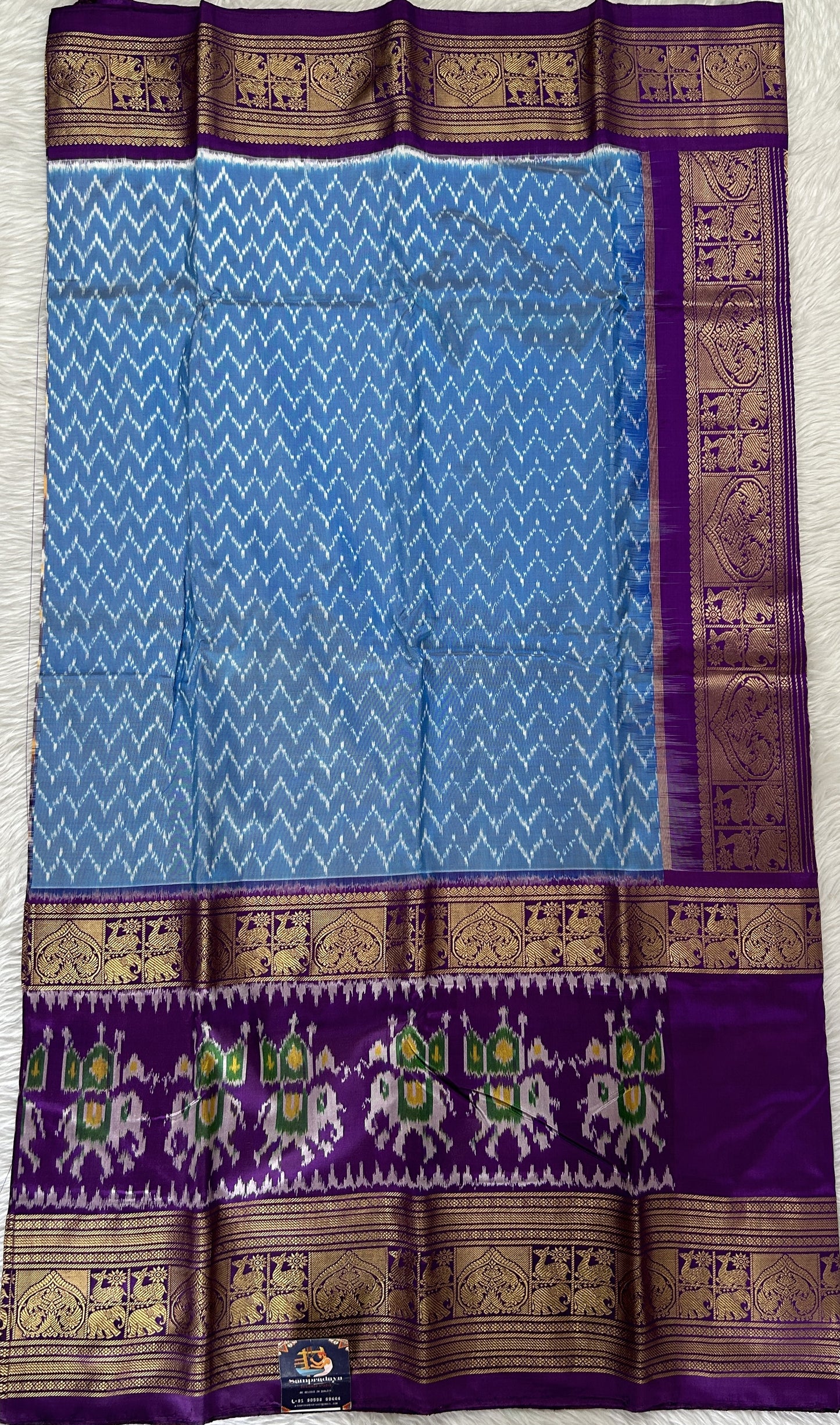 Ikkat Pattu Saree Blue colored Saree complemented with a Purple Colored Kanchi border. - Sampradaya Designer Studio