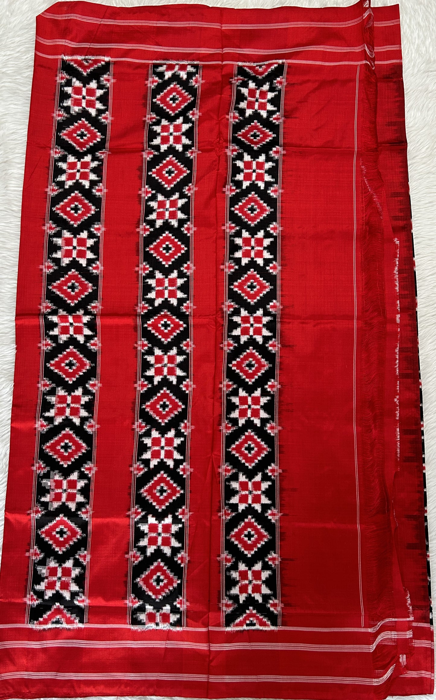 Ikkat Pattu Saree Black colored Saree complemented with a Red Colored Plain border. - Sampradaya Designer Studio