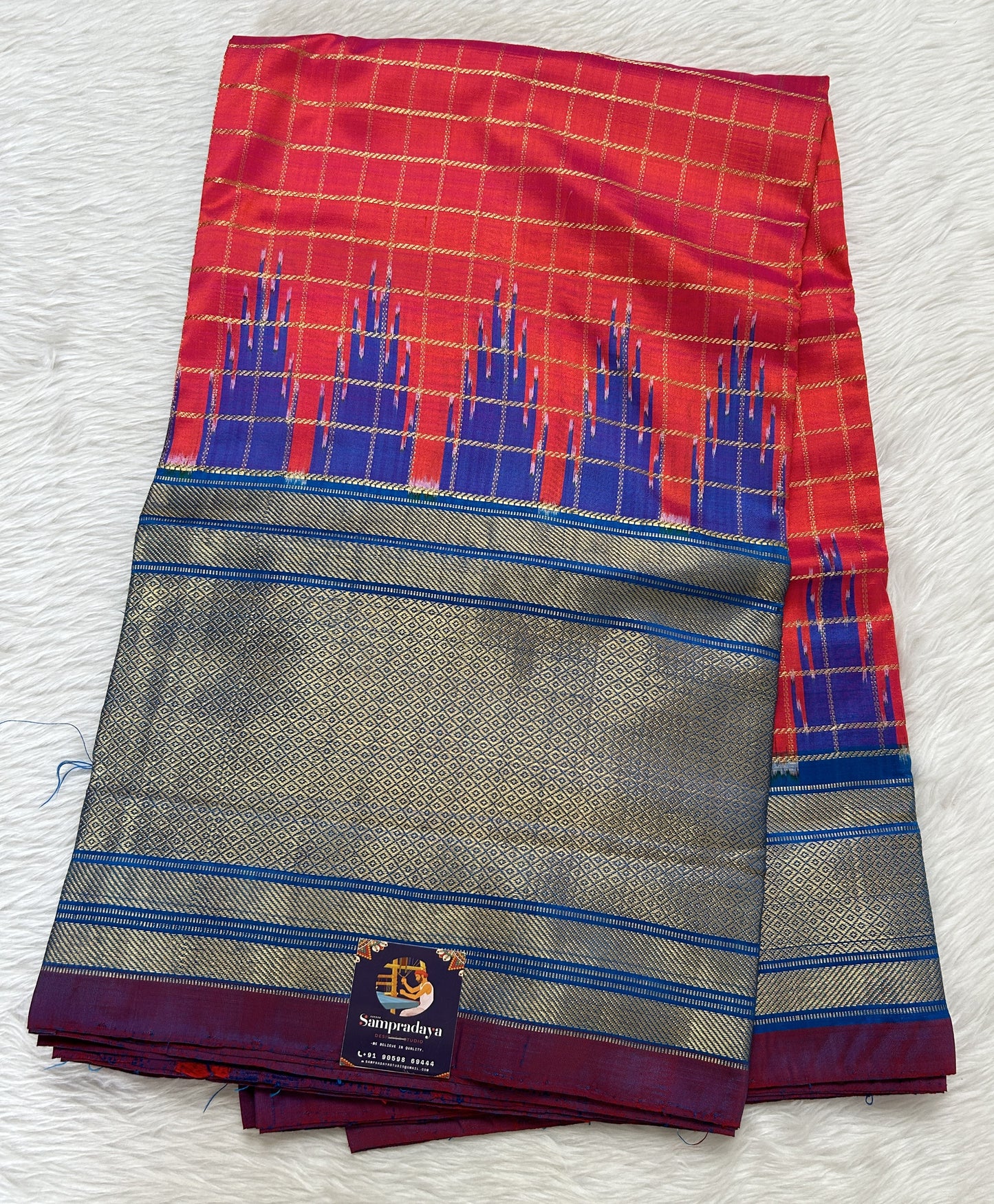 Ikkat Pattu Saree Pink Orange colored Saree complemented with a Blue Colored Kanchi border. - Sampradaya Designer Studio