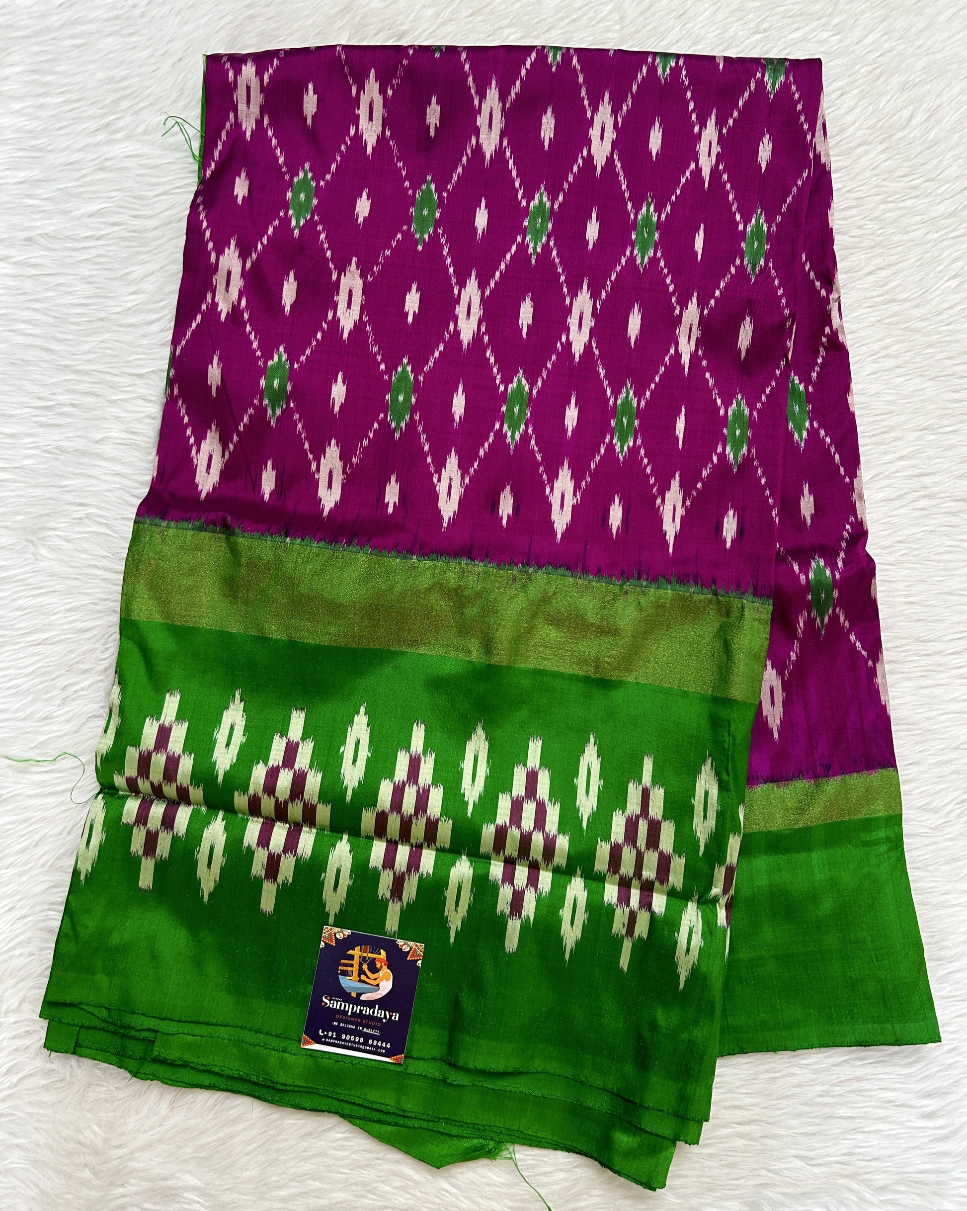 Ikkat Pattu Saree Purple colored Saree complemented with a Green Colored Ikkat border. - Sampradaya Designer Studio