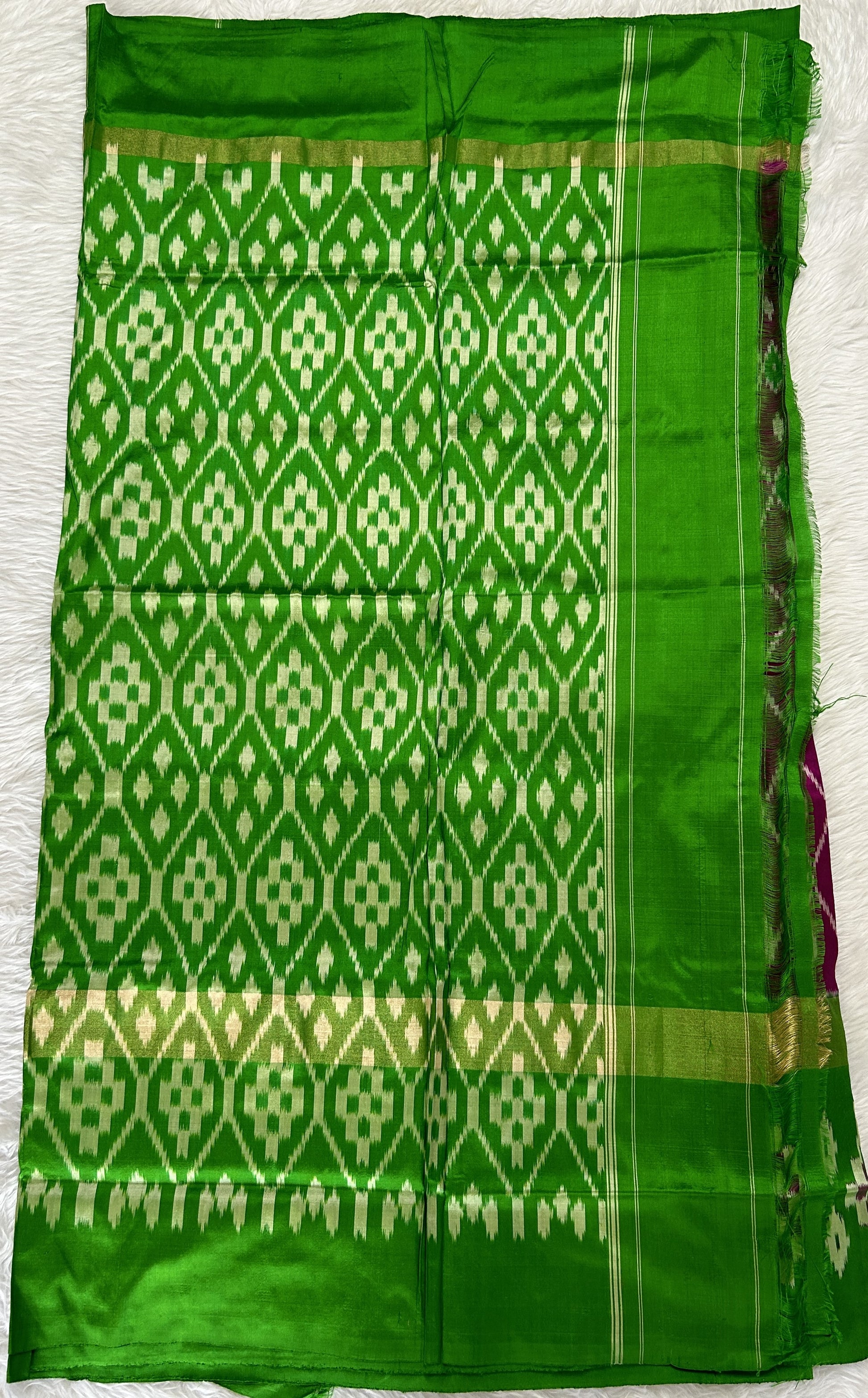 Ikkat Pattu Saree Purple colored Saree complemented with a Green Colored Ikkat border. - Sampradaya Designer Studio