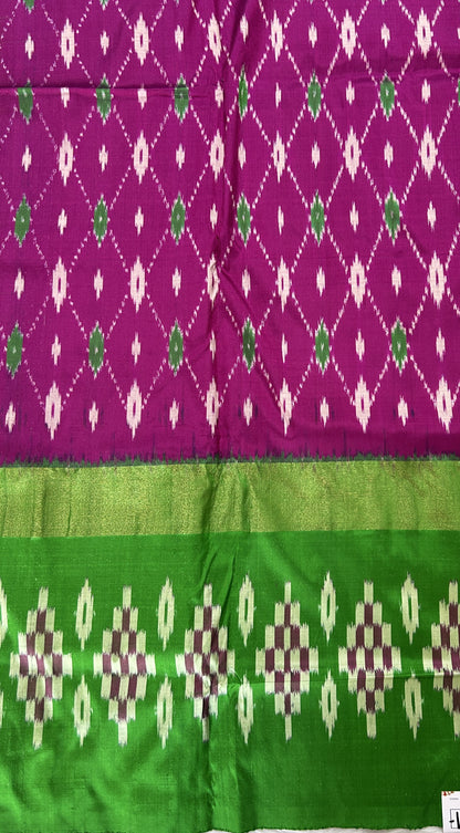 Ikkat Pattu Saree Purple colored Saree complemented with a Green Colored Ikkat border. - Sampradaya Designer Studio