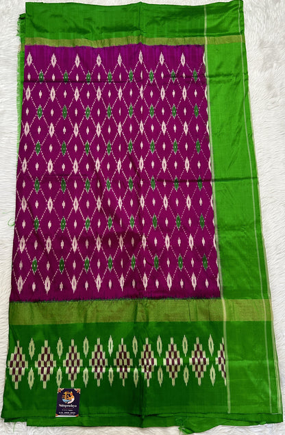 Ikkat Pattu Saree Purple colored Saree complemented with a Green Colored Ikkat border. - Sampradaya Designer Studio