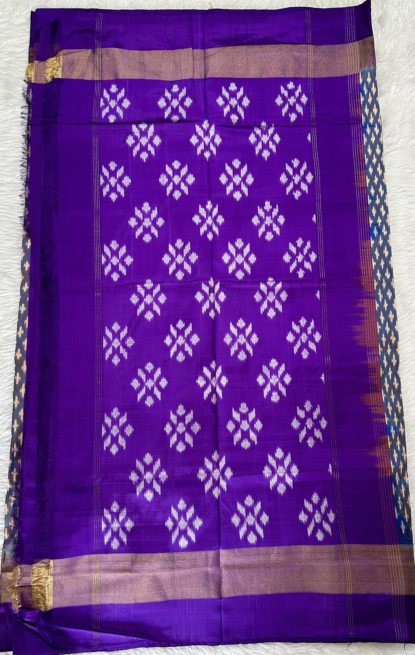 Ikkat Pattu Saree Blue colored Saree complemented with a Purple Colored Plain border. - Sampradaya Designer Studio