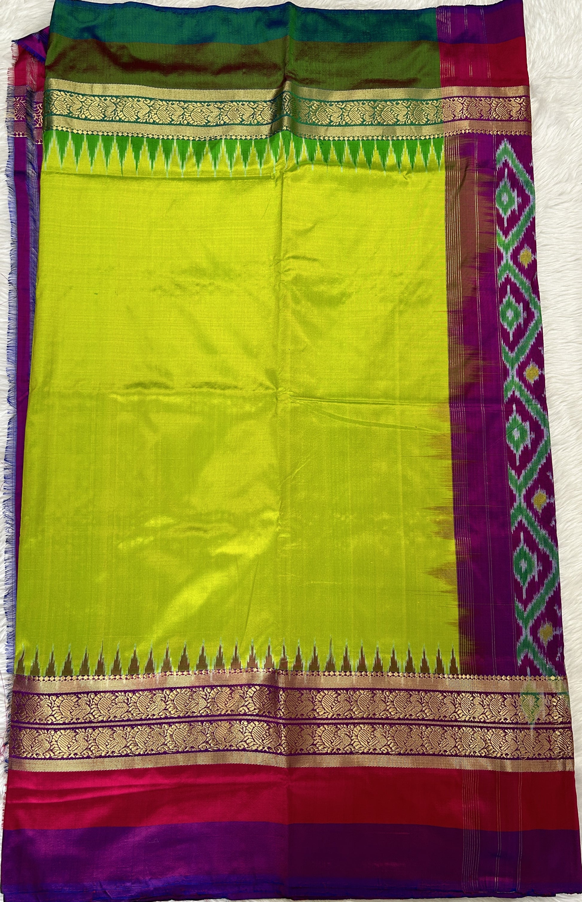 Ikkat Pattu Saree Light Green colored Saree complemented with a Purple and Green Colored Kanchi border. - Sampradaya Designer Studio