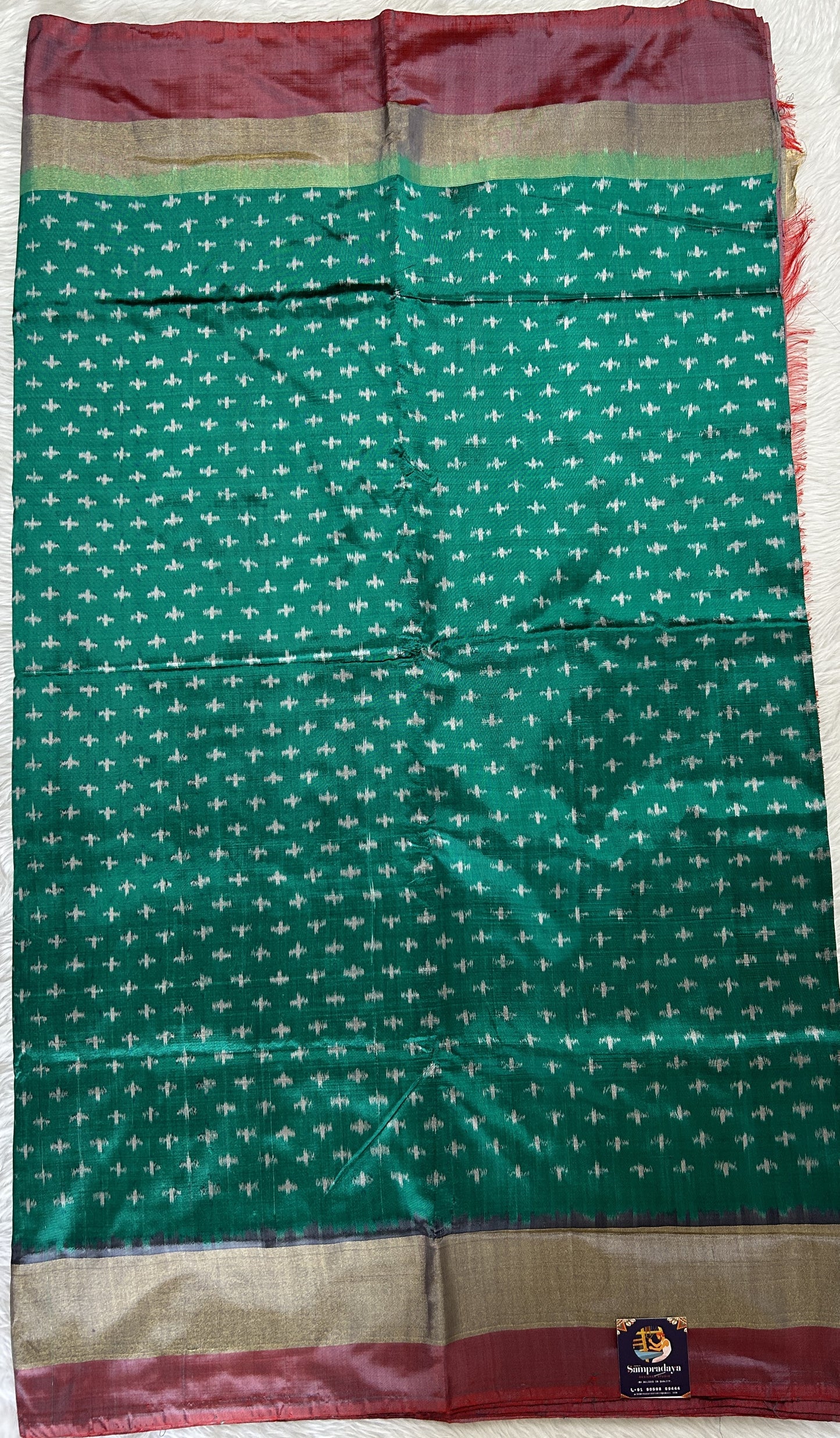 Ikkat Pattu Saree Bottle Green colored Saree complemented with a Onion Pink Colored Plain border. - Sampradaya Designer Studio