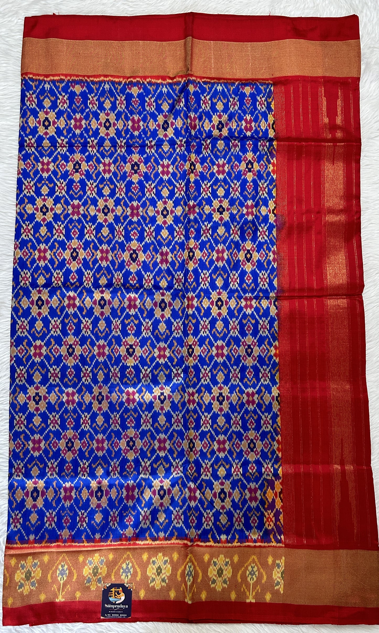 Ikkat Pattu Saree Blue colored Saree complemented with a Red Colored Ikkat border. - Sampradaya Designer Studio