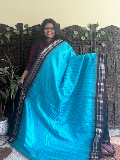 Gadwal Silk Saree Sky Blue Colored Complemented With a Brown Zari Border