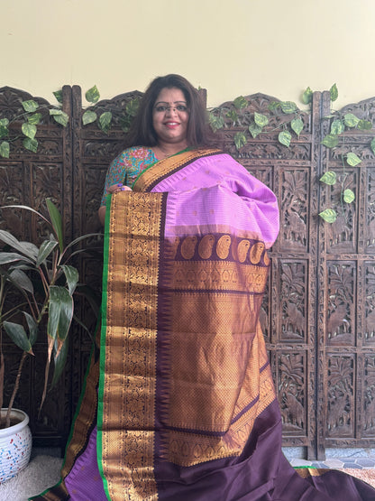 Gadwal Pattu Saree Lavender colored saree complemented with a Brown Zari border