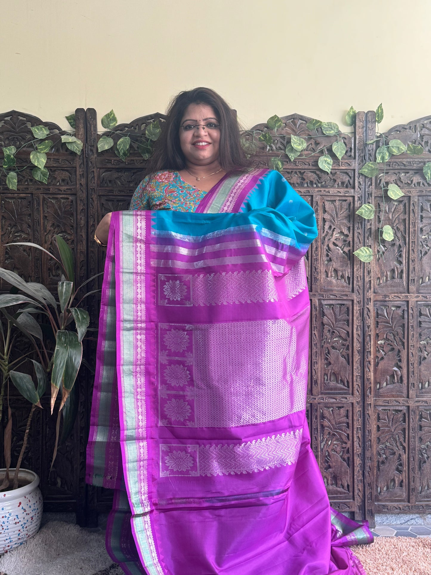 Gadwal Pattu Saree Peacock Blue colored saree complemented with a Purple Zari border