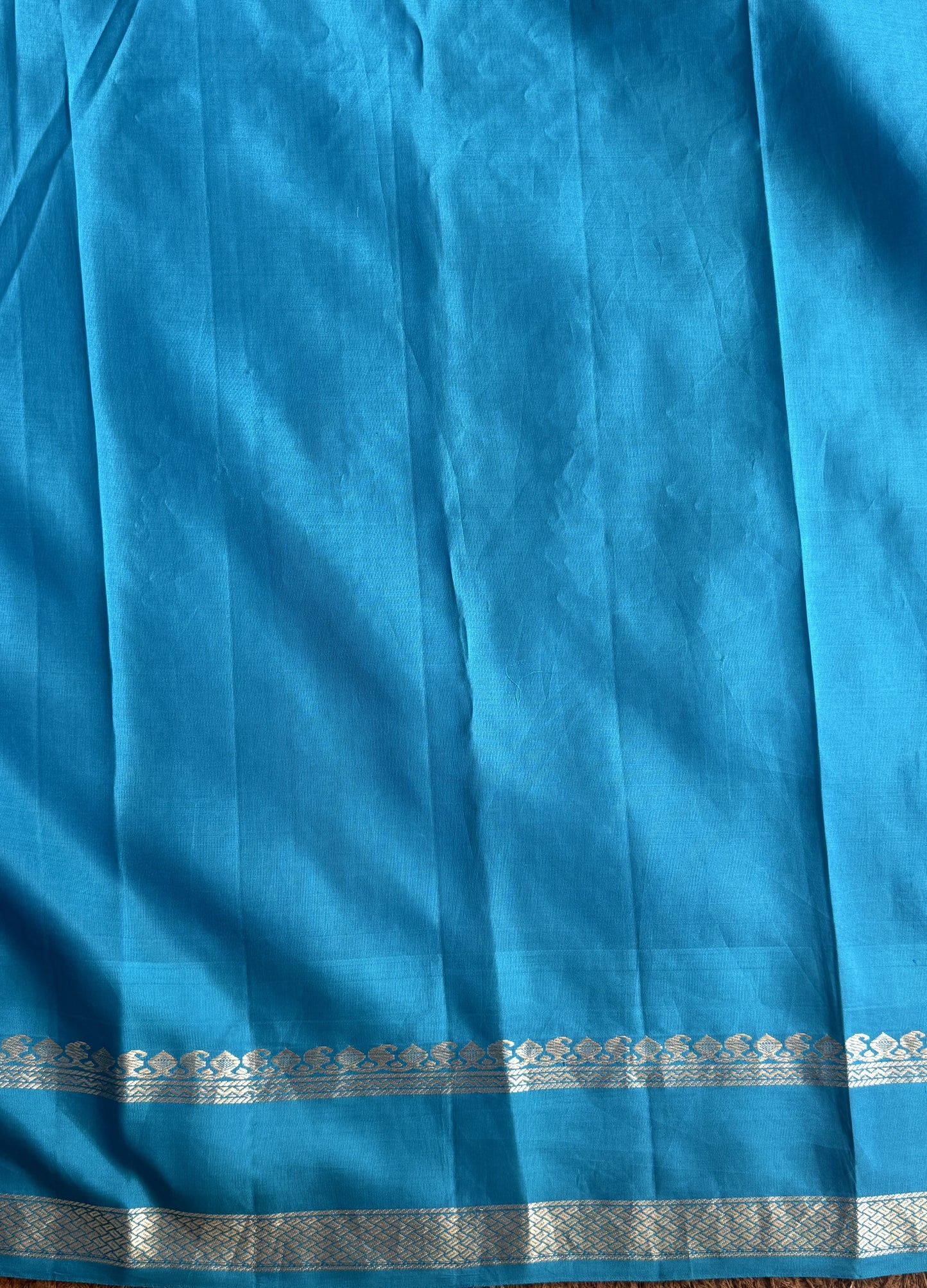 Gadwal Pattu Saree Red colored saree complemented with a Blue Zari border