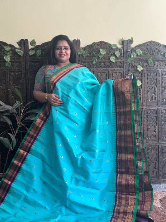 Gadwal Pattu Saree Sea Blue colored saree complemented with a Purple Zari border