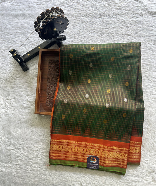 Gadwal Pattu Saree Bottle Green Colored Complemented With a Zari Border - Sampradaya Designer Studio